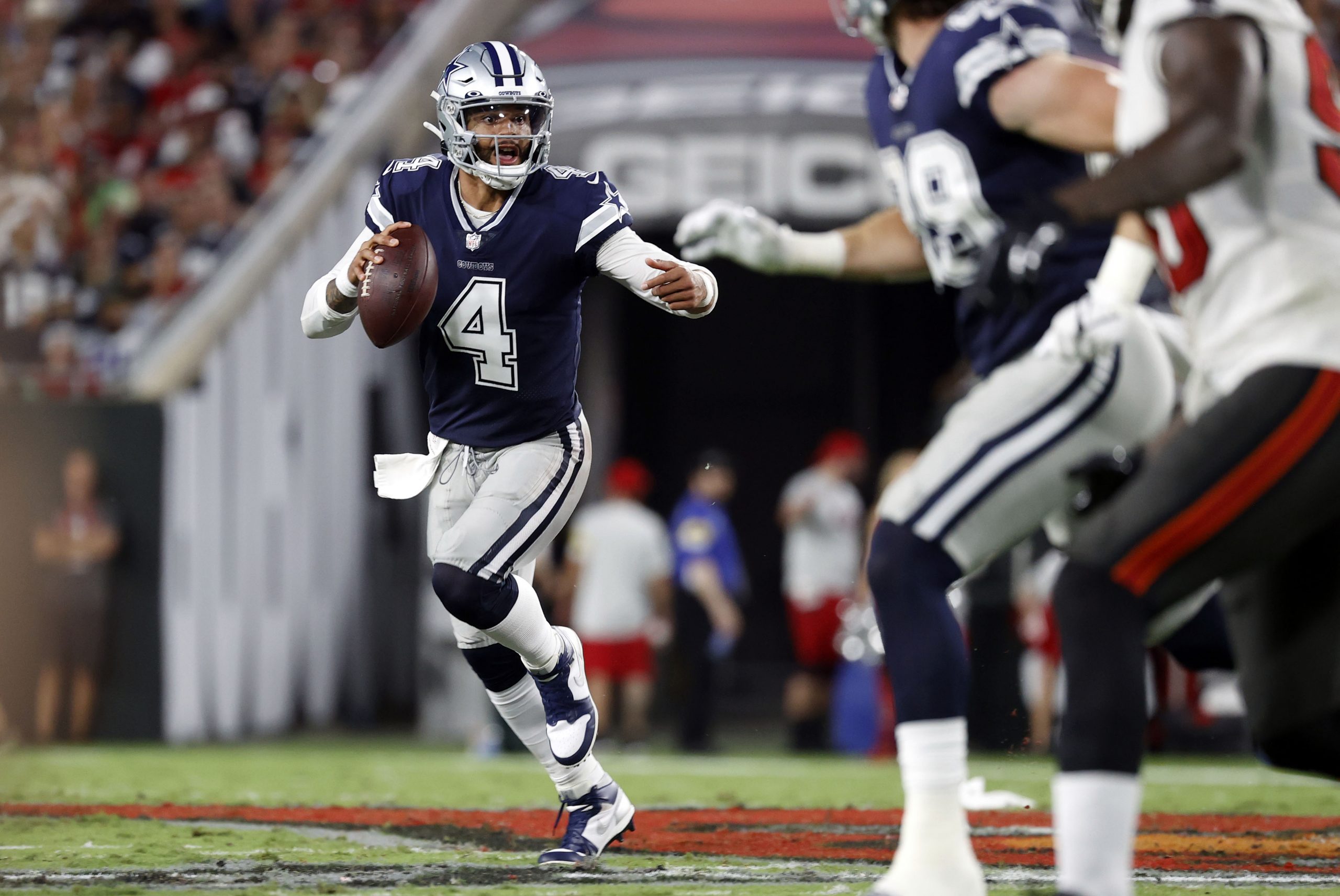 Dallas Cowboys quarterback Dak Prescott (4) rolls out of the pocket against the Tampa Bay Buccaneers during the first half at Raymond James Stadium.