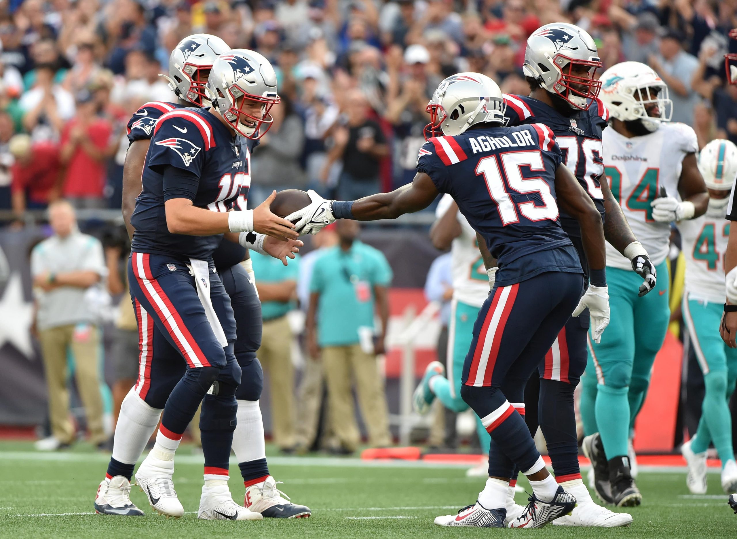 New England Patriots wide receiver Nelson Agholor (15) hands the ball to quarterback Mac Jones (10) after throwing his first touchdown pass during the first half against the Miami Dolphins at Gillette Stadium.