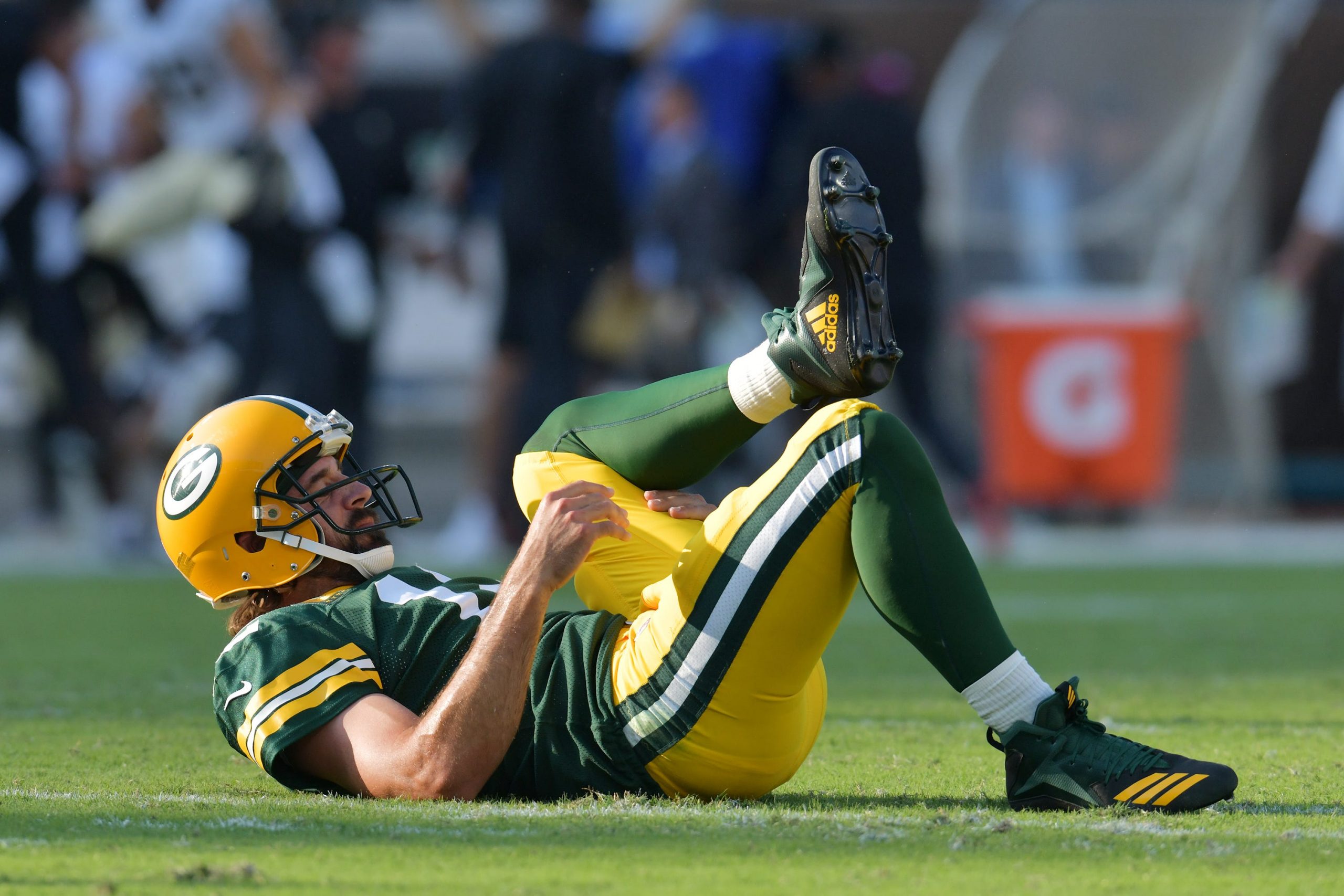 Green Bay Packers quarterback Aaron Rodgers (12) on the turf after throwing a pass that was intercepted by New Orleans Saints cornerback Paulson Adebo (29) during early third quarter action.