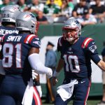 New England Patriots quarterback Mac Jones (10) celebrates with offensive guard Alijah Vera-Tucker (75) and tight end Jonnu Smith (81) after a Patriots touchdown during the second half against the New York Jets.