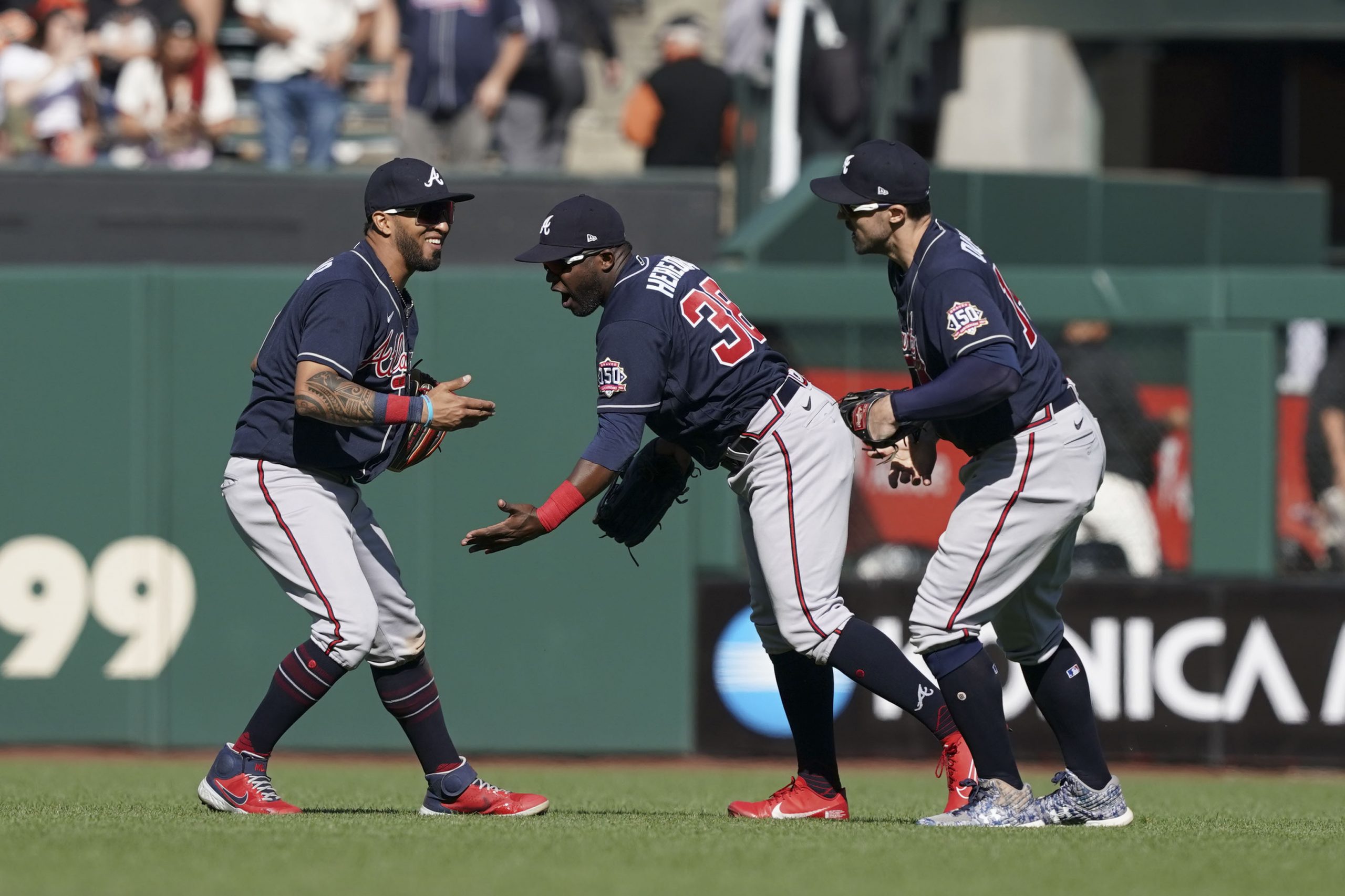 Sep 19, 2021; San Francisco, California, USA; Atlanta Braves left fielder Eddie Rosario (8) celebrates with center fielder Guillermo Heredia (38) and right fielder Adam Duvall (14) after the game against the San Francisco Giants at Oracle Park.