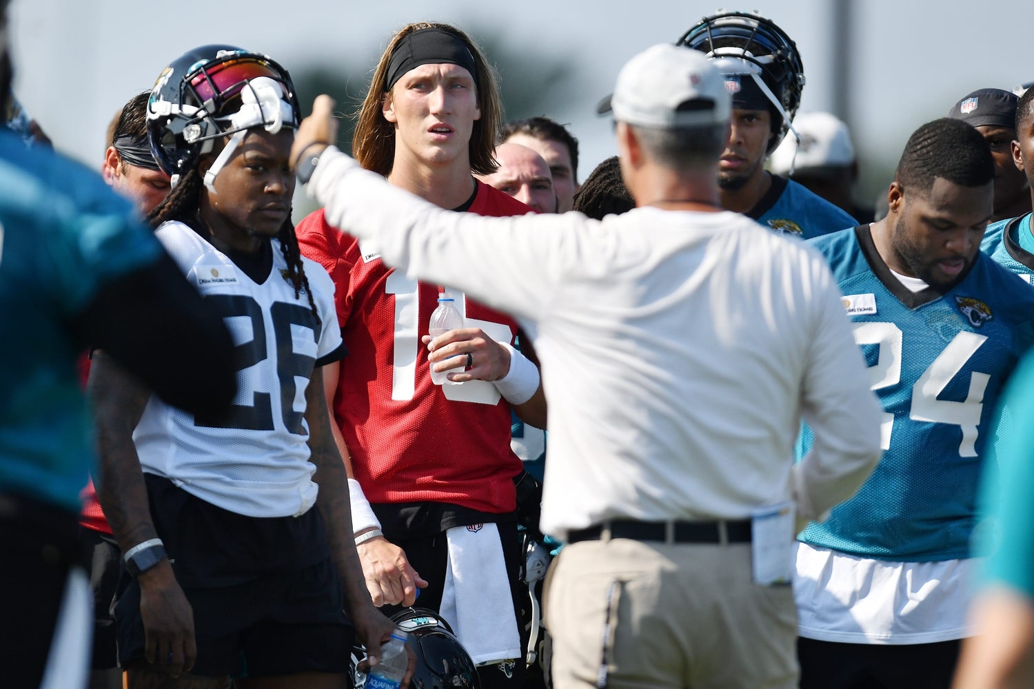 Jaguars quarterback (16) Trevor Lawrence and teammates listen as head coach Urban Meyer talks with his team between drills at Wednesday's training camp session, The Jacksonville Jaguars training camp