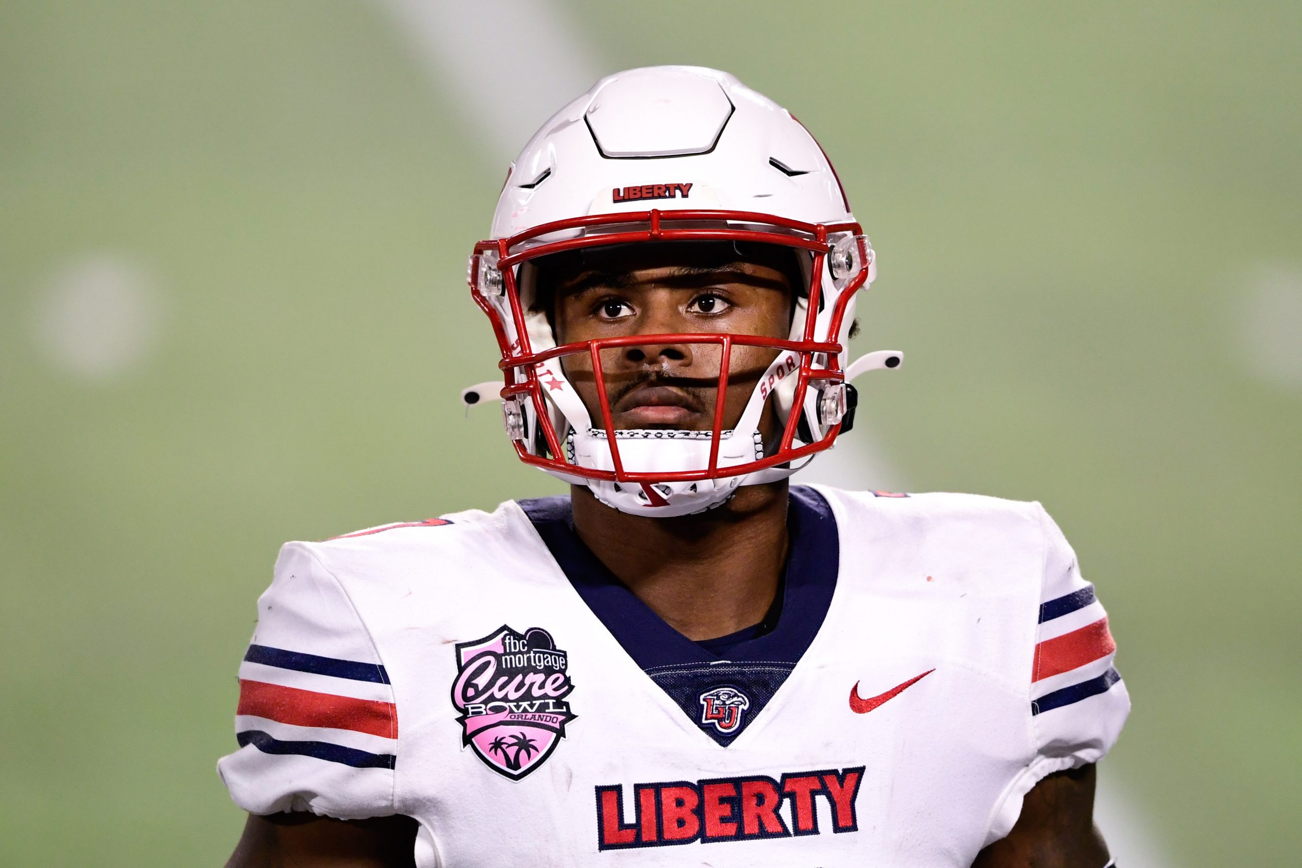 Dec 26, 2020; Orlando, FL, USA; Liberty Flames quarterback Malik Willis (7) looks on during the second half against the Coastal Carolina Chanticleers during the Cure Bowl at Camping World Stadium.