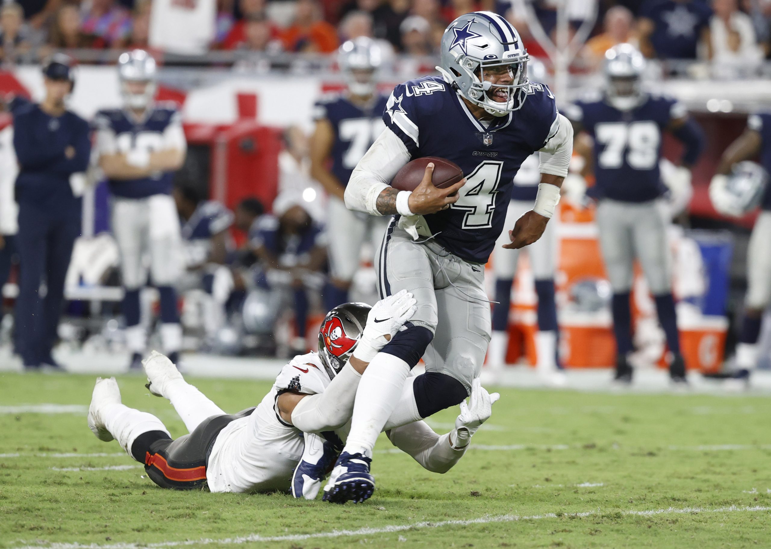 Sep 9, 2021; Tampa, Florida, USA; Dallas Cowboys quarterback Dak Prescott (4) runs the ball against Tampa Bay Buccaneers linebacker Joe Tryon-Shoyinka (9) during the first half at Raymond James Stadium.