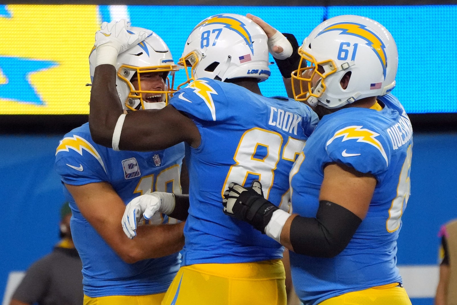 Los Angeles Chargers tight end Jared Cook (87) celebrates with quarterback Justin Herbert (left) and center Scott Quessenberry (61) after catching a pass for a touchdown against the Las Vegas Raiders.