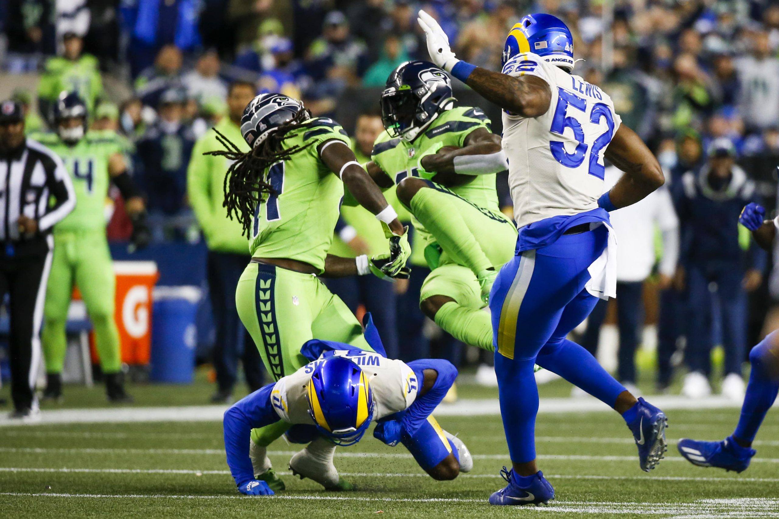 Seattle Seahawks wide receiver DK Metcalf (14) is tackled after catching a pass against the Los Angeles Rams during the fourth quarter at Lumen Field
