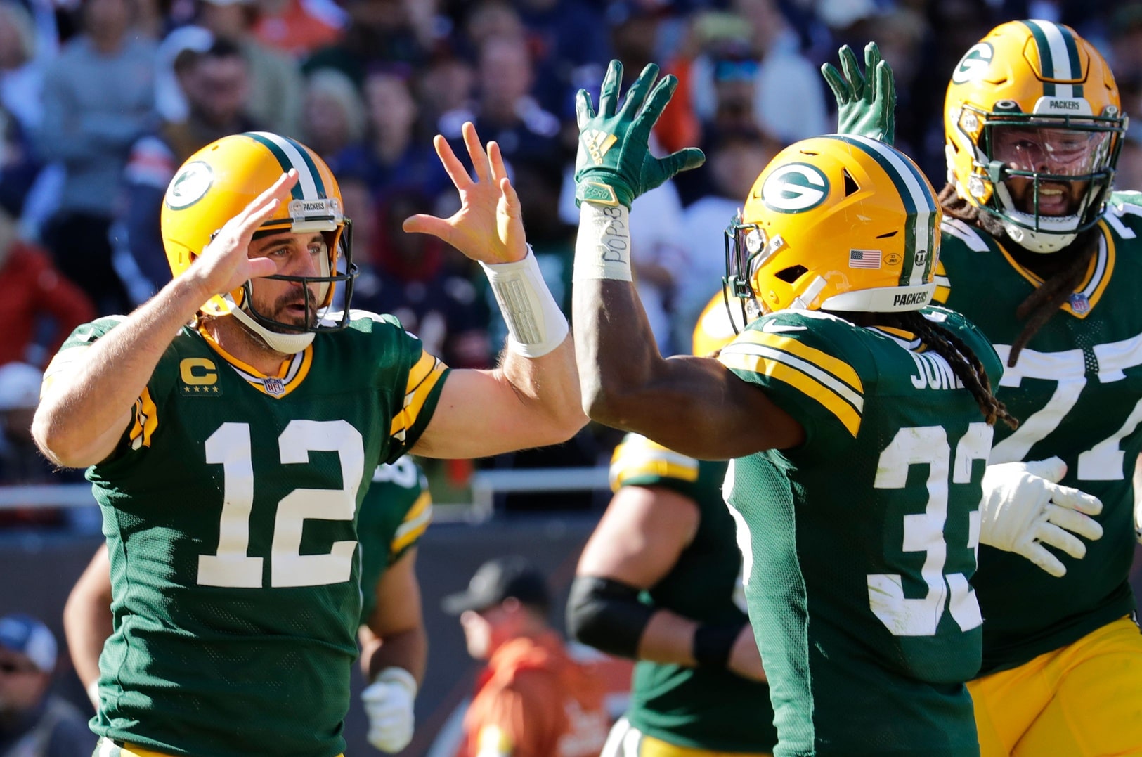 Green Bay Packers quarterback Aaron Rodgers (12) celebrates scoring a touchdown in the fourth quarter with running back Aaron Jones (33) during their football game Sunday, October 17, 2021, at Soldier Field