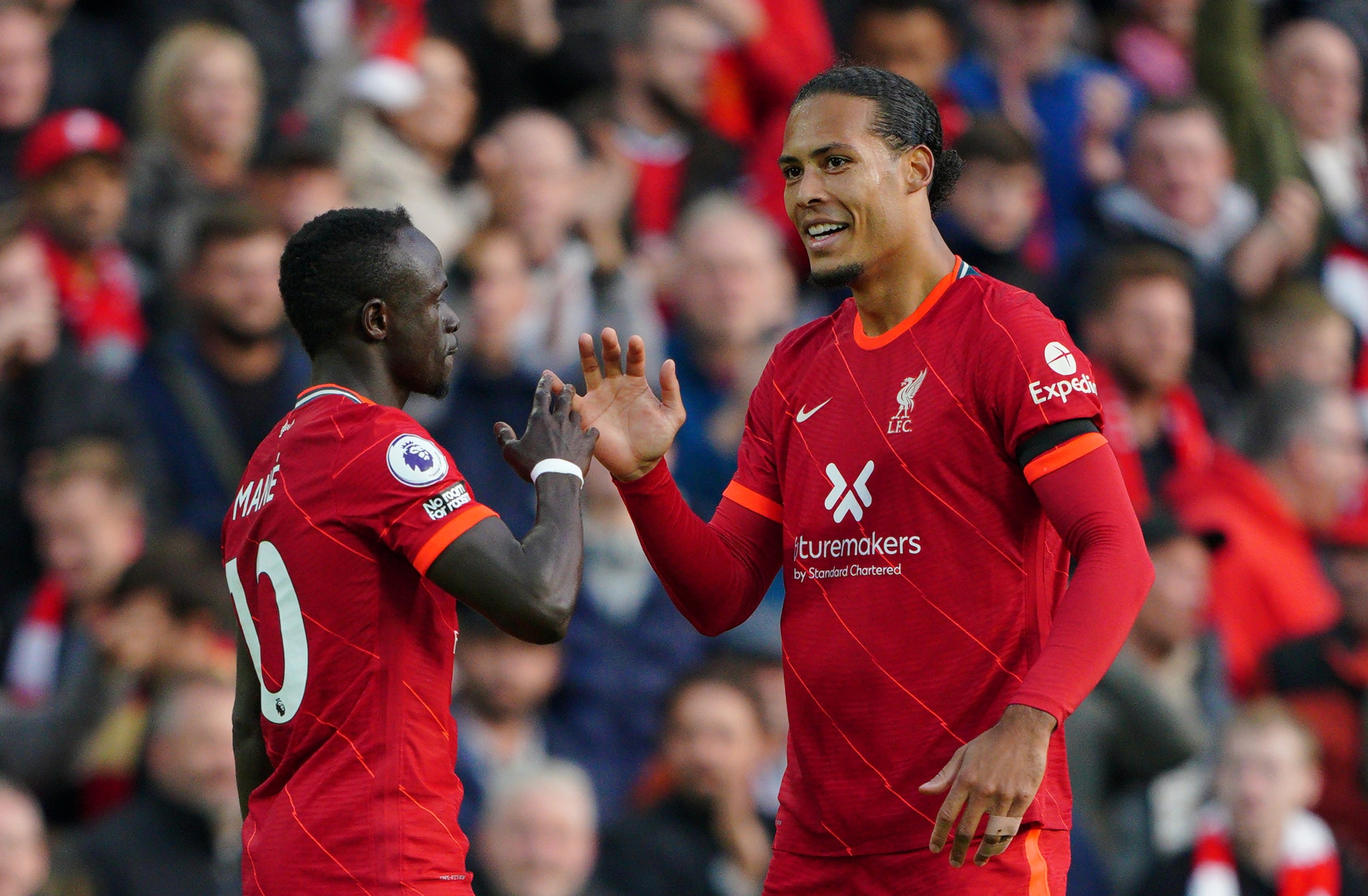 Liverpool's Sadio Mane (left) celebrates with Virgil van Dijk after scoring their side's first goal of the game during the Premier League match at Anfield, Liverpool.