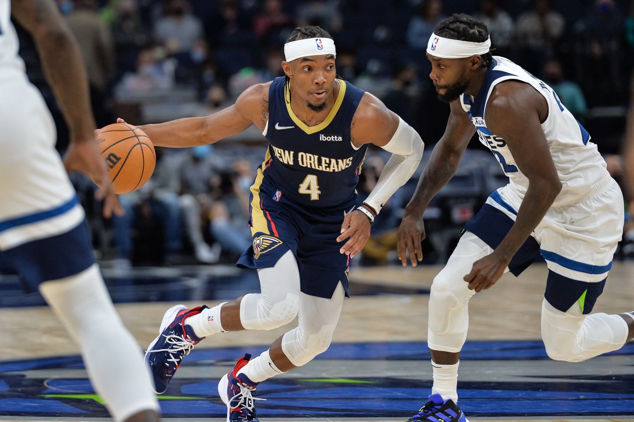 New Orleans Pelicans guard Devonte' Graham (4) controls the ball as Minnesota Timberwolves guard Patrick Beverley (22) defends during the fourth quarter at Target Center.