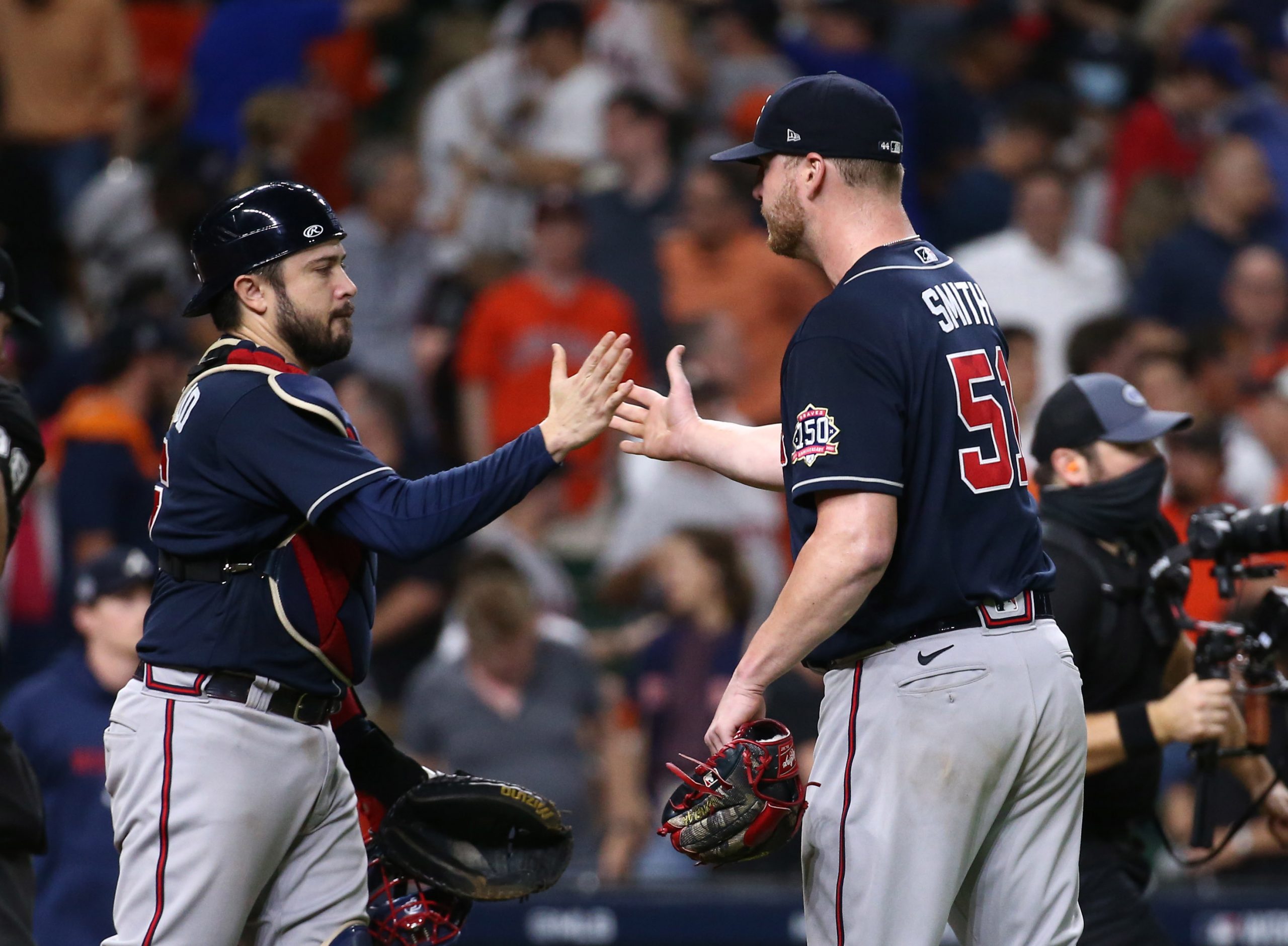 Atlanta Braves relief pitcher Will Smith (51) and catcher Travis d'Arnaud (16) celebrate after defeating the Houston Astros in game one of the 2021 World Series at Minute Maid Park