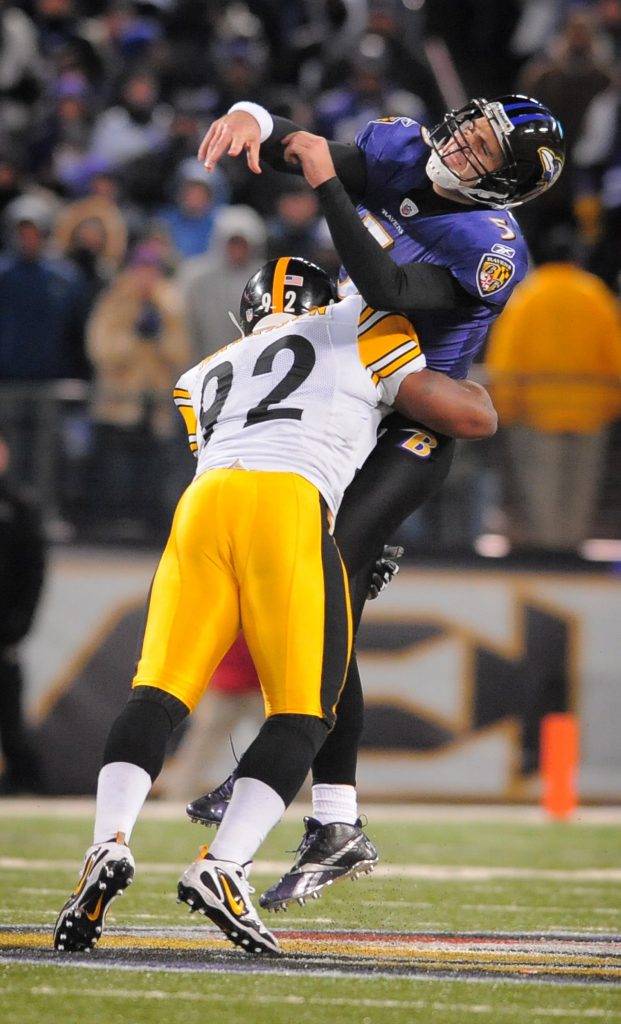 Baltimore Ravens quarterback Joe Flacco is hit hard by Pittsburgh Steelers linebacker James Harrison
