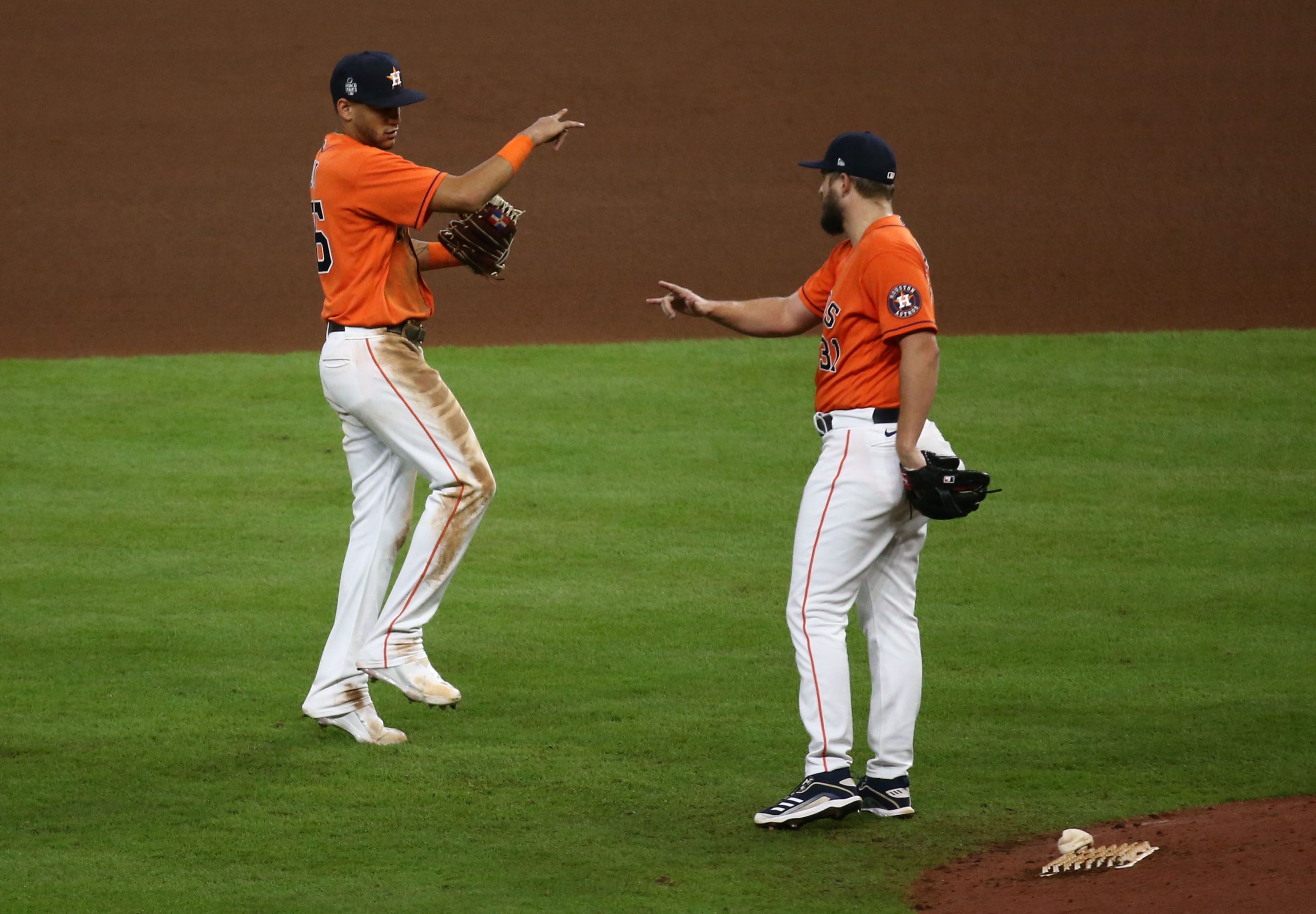 Houston Astros players Jose Siri (26) and Kendall Graveman (31) celebrate after defeating the Atlanta Braves in game two of the 2021 World Series at Minute Maid Park