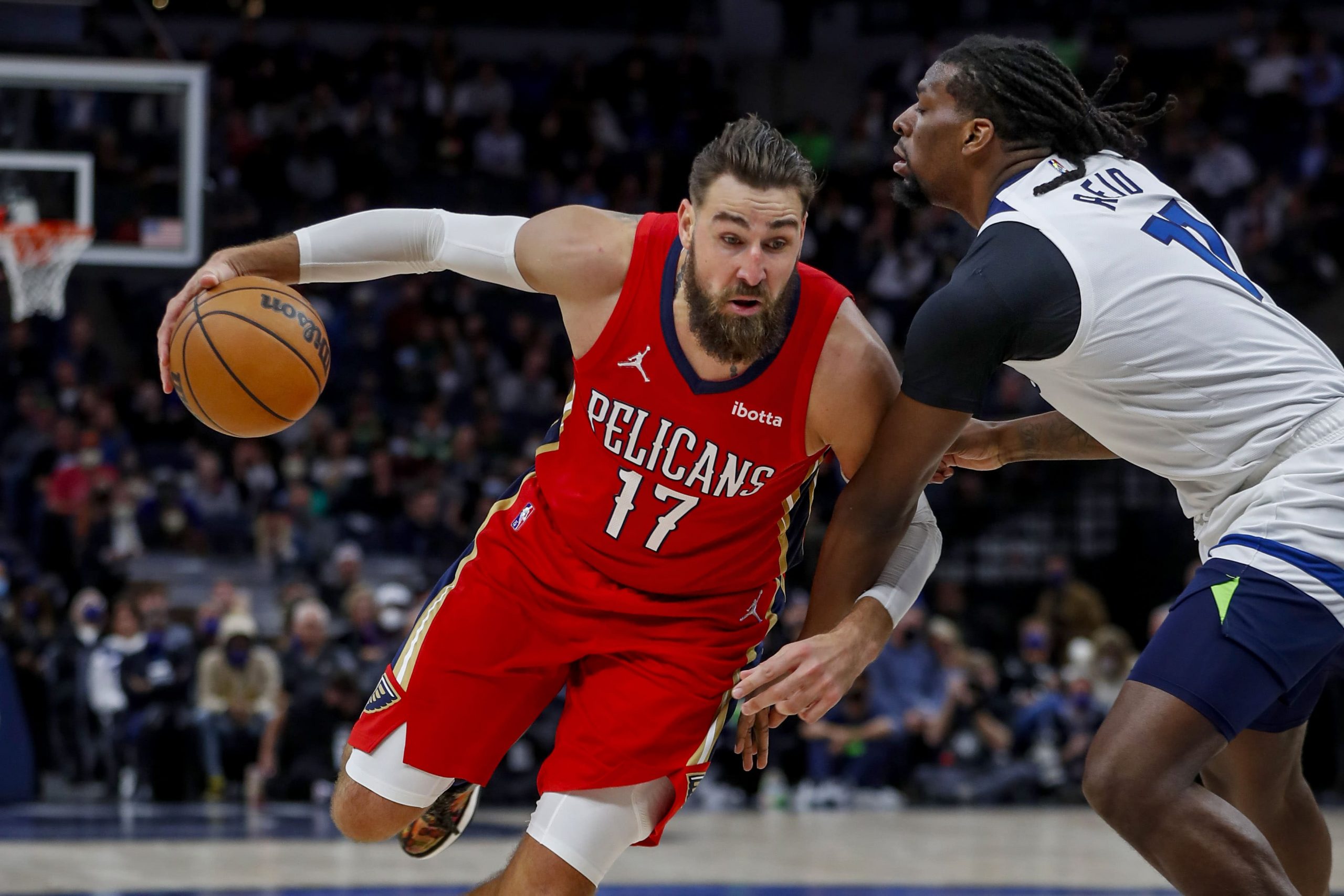 New Orleans Pelicans center Jonas Valanciunas (17) dribbles the ball around Minnesota Timberwolves center Naz Reid (11) in the fourth quarter at Target Center.