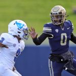 Akron Zips quarterback DJ Irons (0) rushes to the sideline as he picks up a first down against Buffalo Bulls cornerback Aapri Washington (3) during the first half of an NCAA college football game