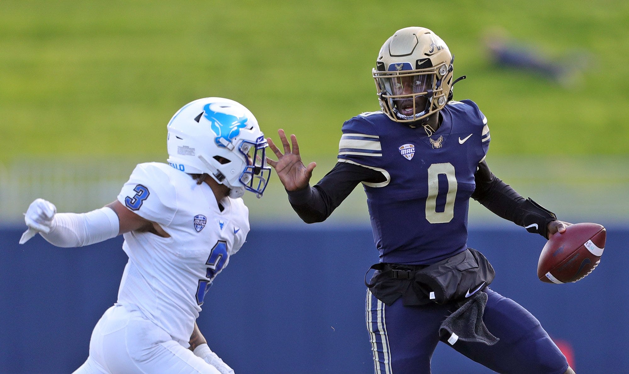 Akron Zips quarterback DJ Irons (0) rushes to the sideline as he picks up a first down against Buffalo Bulls cornerback Aapri Washington (3) during the first half of an NCAA college football game