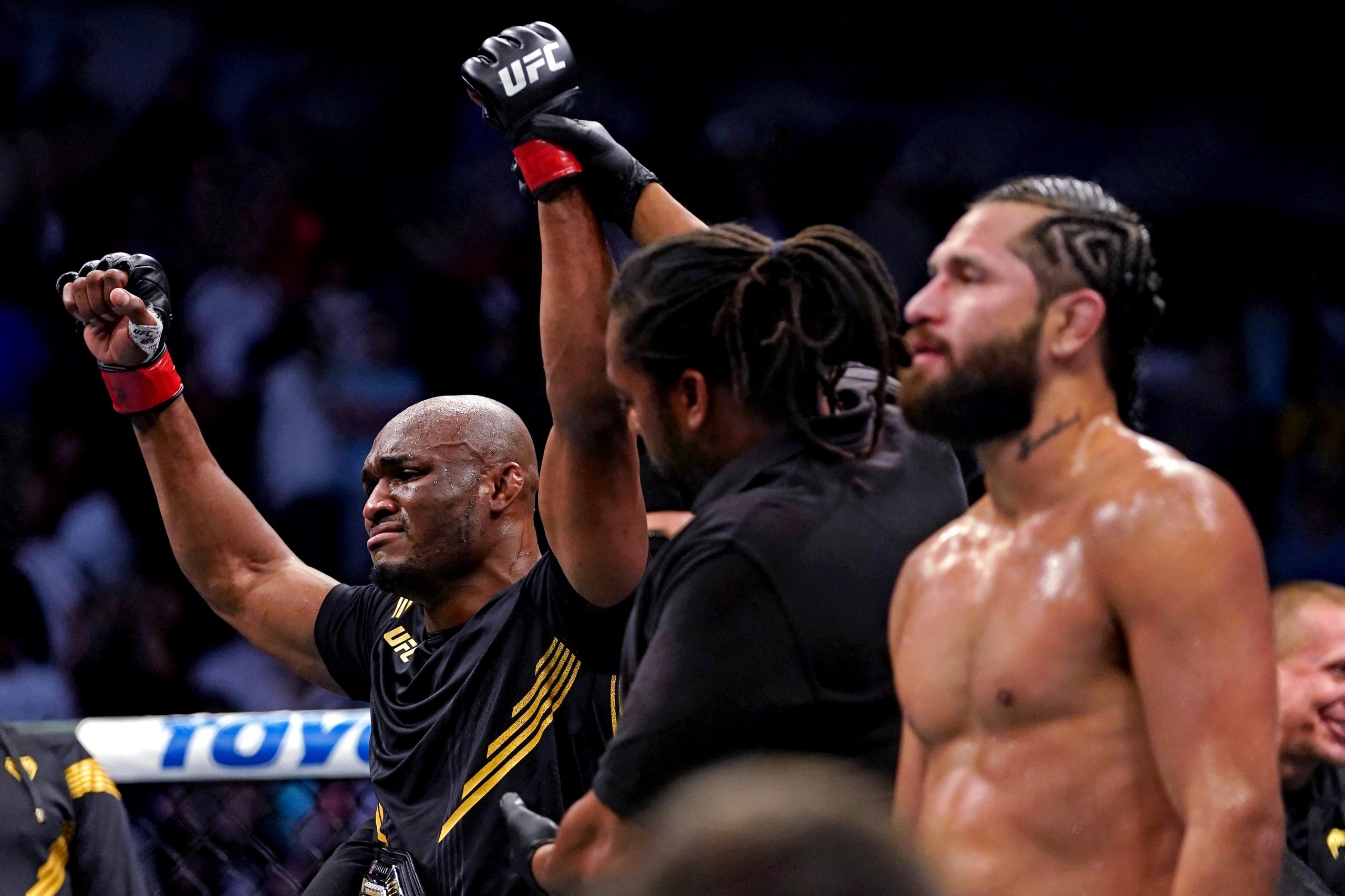 Kamaru Usman (Red Gloves) reacts after defeating Jorge Masvidal (Blue Gloves) during UFC 261 at VyStar Veterans Memorial Arena