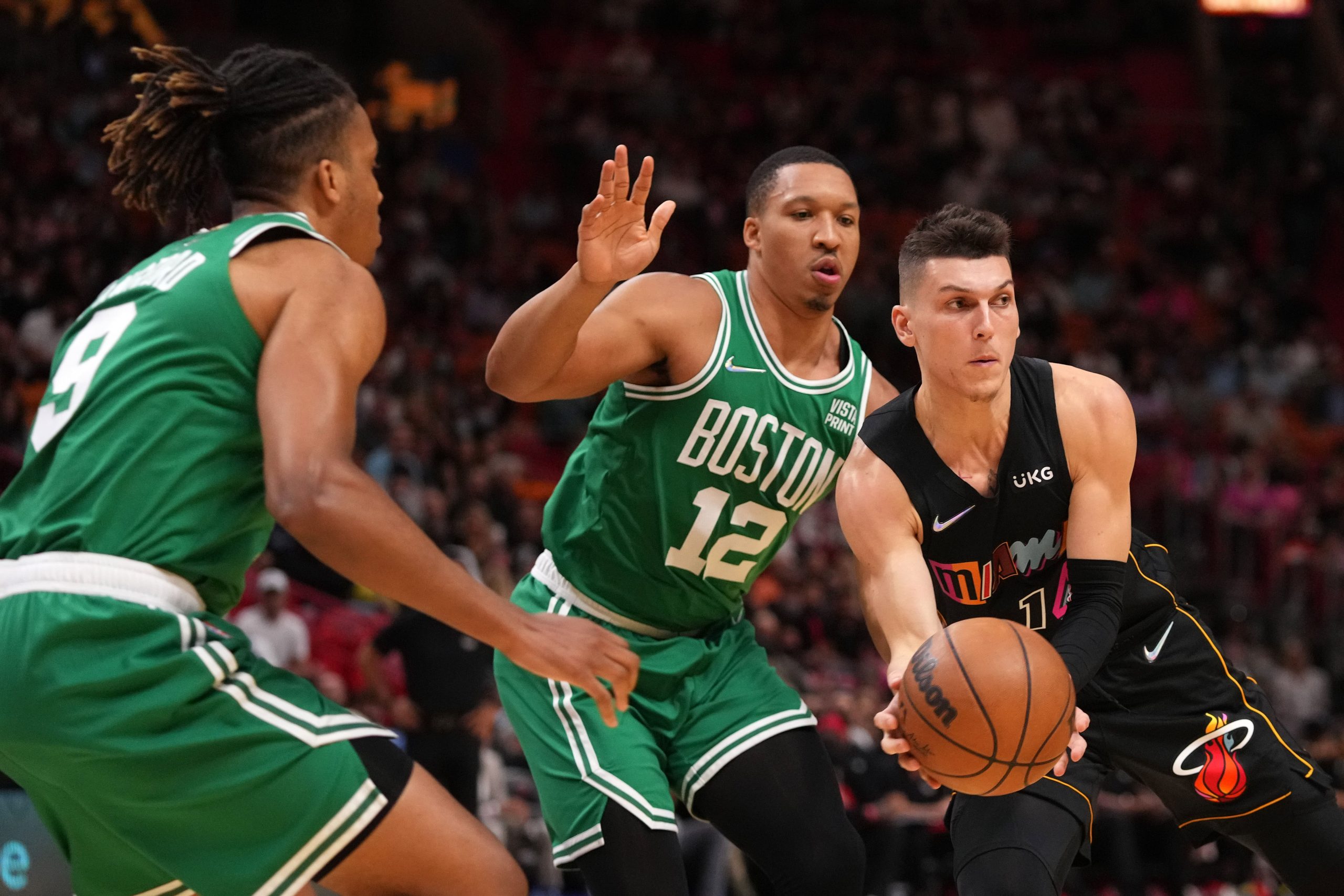 Miami Heat guard Tyler Herro (14) passes the ball away from Boston Celtics forward Grant Williams (12) during the first half at FTX Arena.