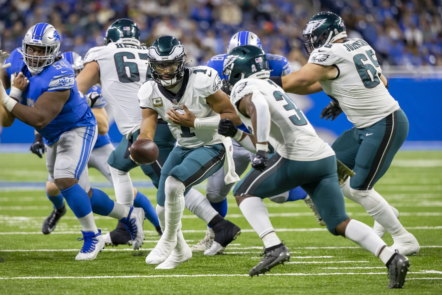 Philadelphia Eagles quarterback Jalen Hurts (1) hands off the football to running back Boston Scott (35) in the second quarter against the Detroit Lions at Ford Field.