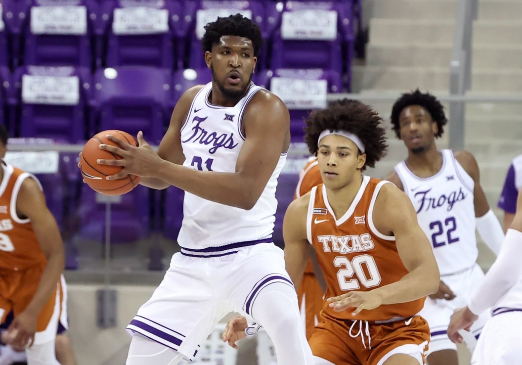 TCU Horned Frogs center Kevin Samuel (21) looks to pass as Texas Longhorns forward Jericho Sims (20) defends during the second half at Ed and Rae Schollmaier Arena.