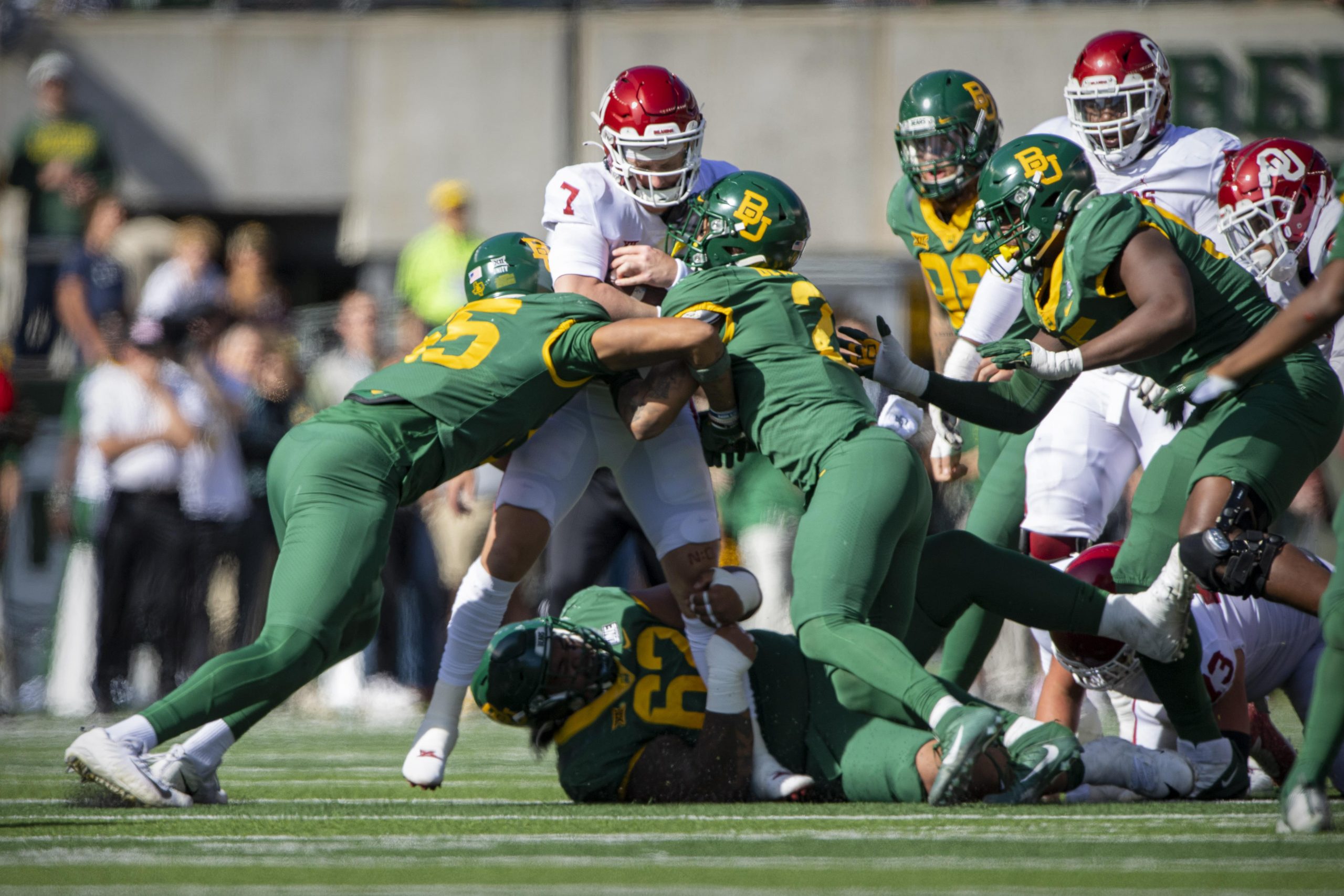 Oklahoma Sooners QB Spencer Rattler is tackled by the Baylor Bears