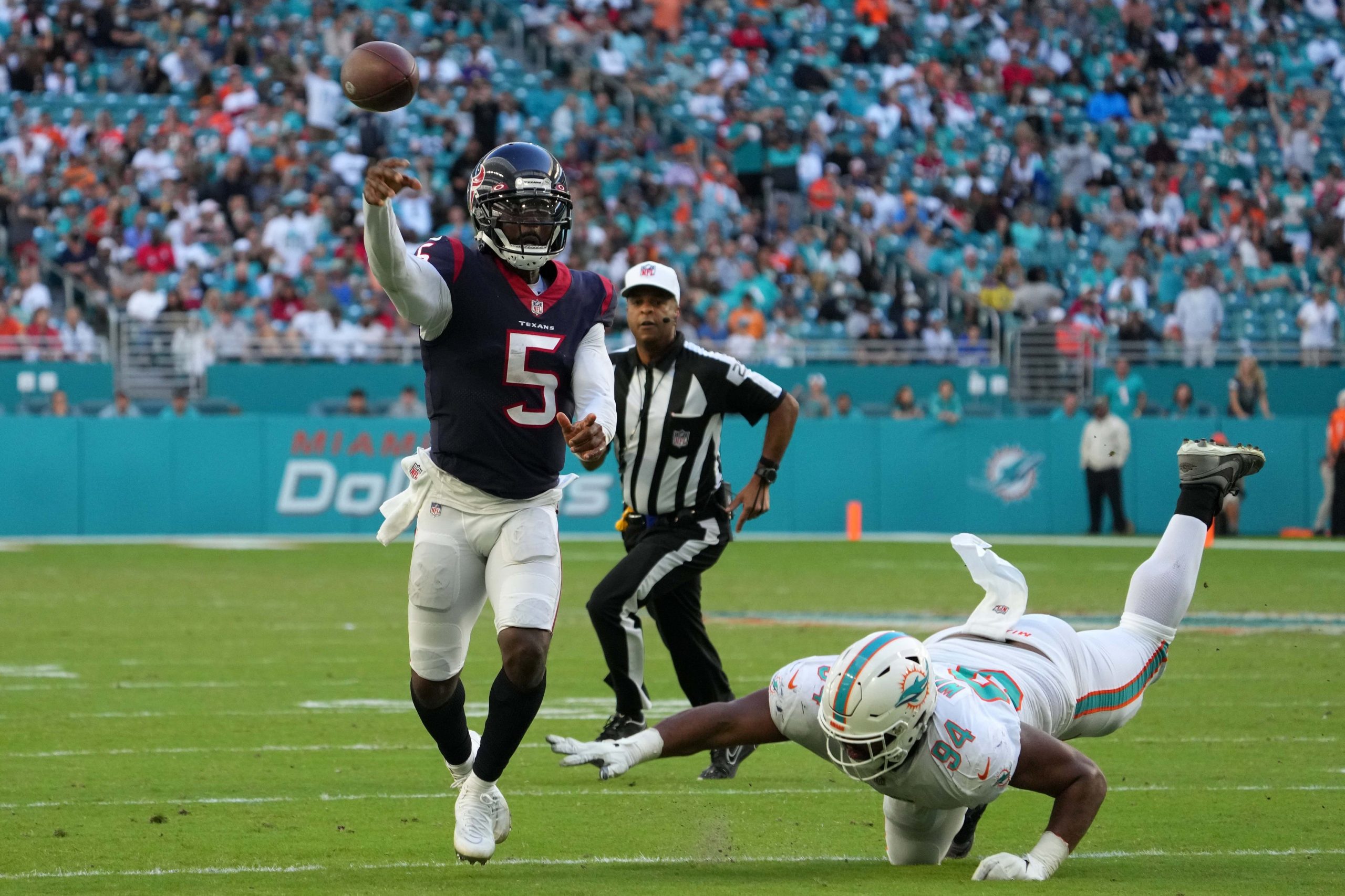 Houston Texans quarterback Tyrod Taylor (5) attempts a pass under pressure from Miami Dolphins defensive end Christian Wilkins (94) during the second half at Hard Rock Stadium.
