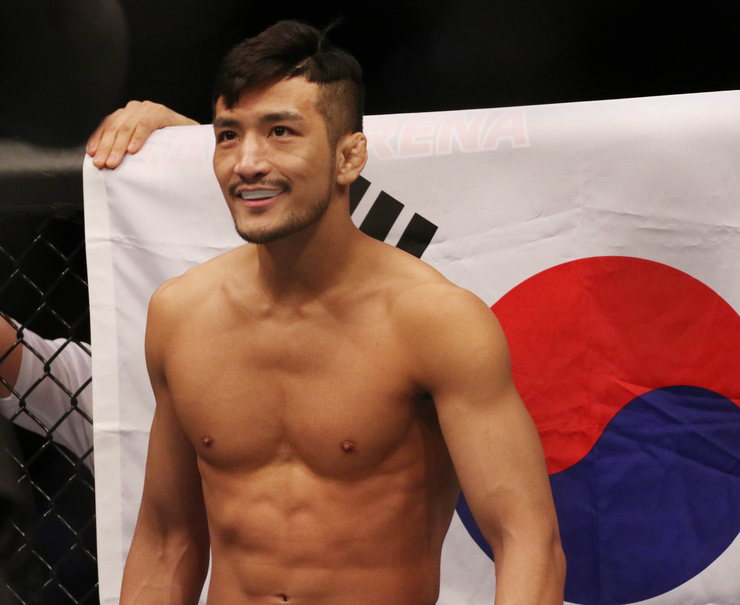 Dec 21, 2019; Busan, SOUTH KOREA; Kyung Ho Kang (red gloves) is introduced before fighting Liu Pingyuan (blue gloves) during UFC Fight Night at Sajik Arena.