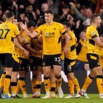 Wolverhampton Wanderers players celebrate after Raul Jimenez (hidden) scores their side's first goal of the game during the Premier League match at Molineux Stadium, Wolverhampton.