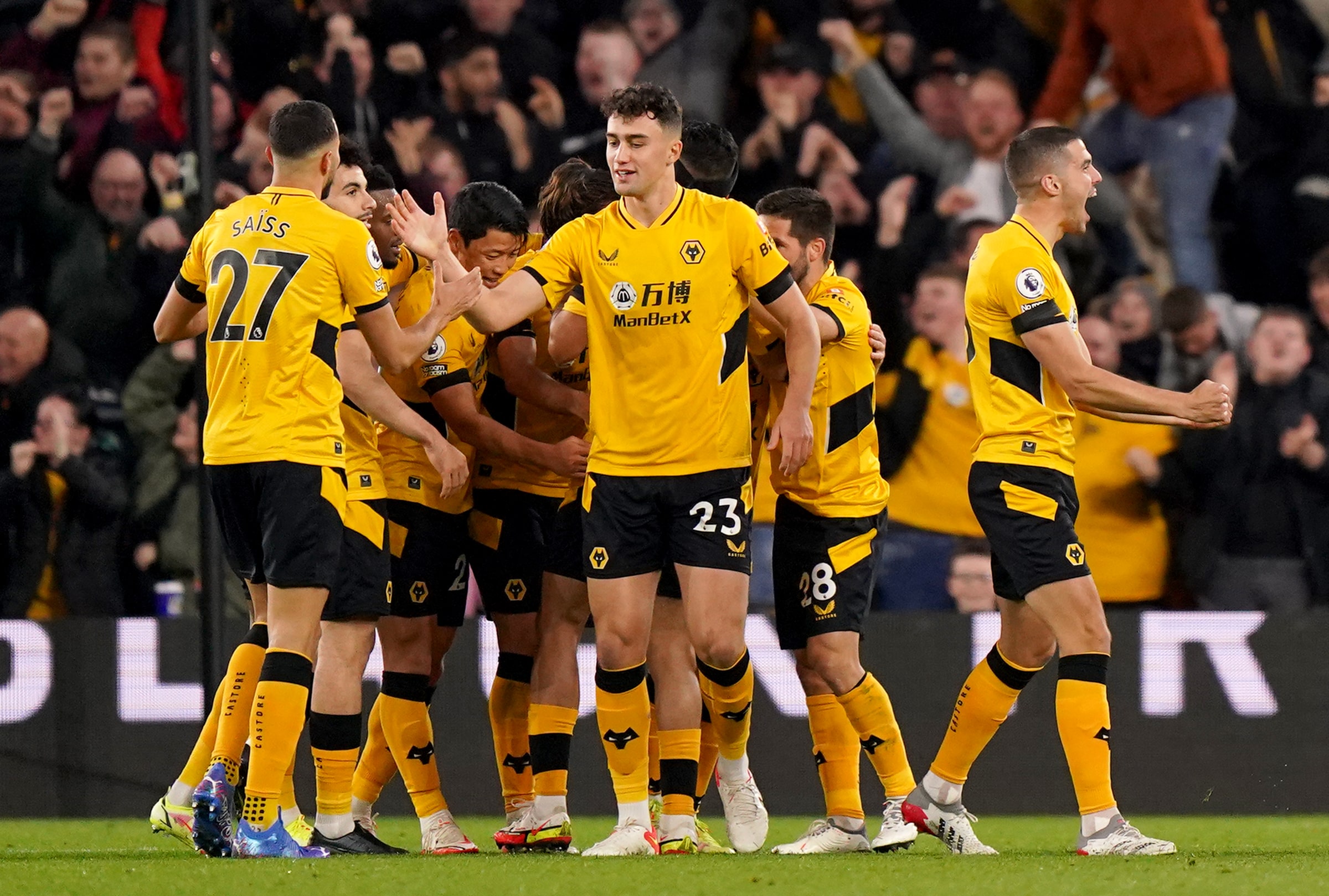 Wolverhampton Wanderers players celebrate after Raul Jimenez (hidden) scores their side's first goal of the game during the Premier League match at Molineux Stadium, Wolverhampton.