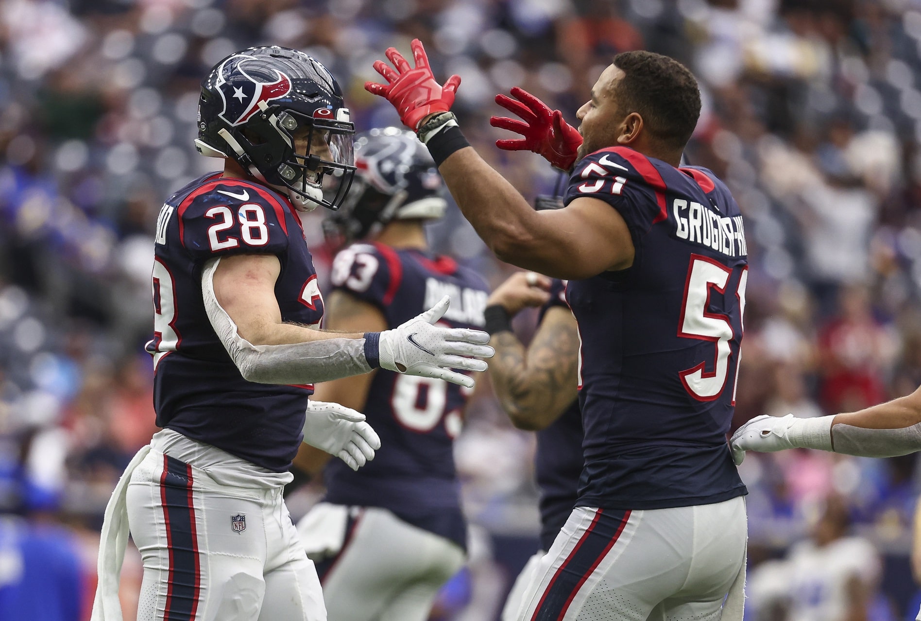 Houston Texans running back Rex Burkhead (28) celebrates with outside linebacker Kamu Grugier-Hill (51) after scoring a touchdown during the fourth quarter against the Los Angeles Rams at NRG Stadium.