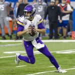 Minnesota Vikings quarterback Kirk Cousins (8) scrambles out of the pocket against the Detroit Lions in the first half at Ford Field.