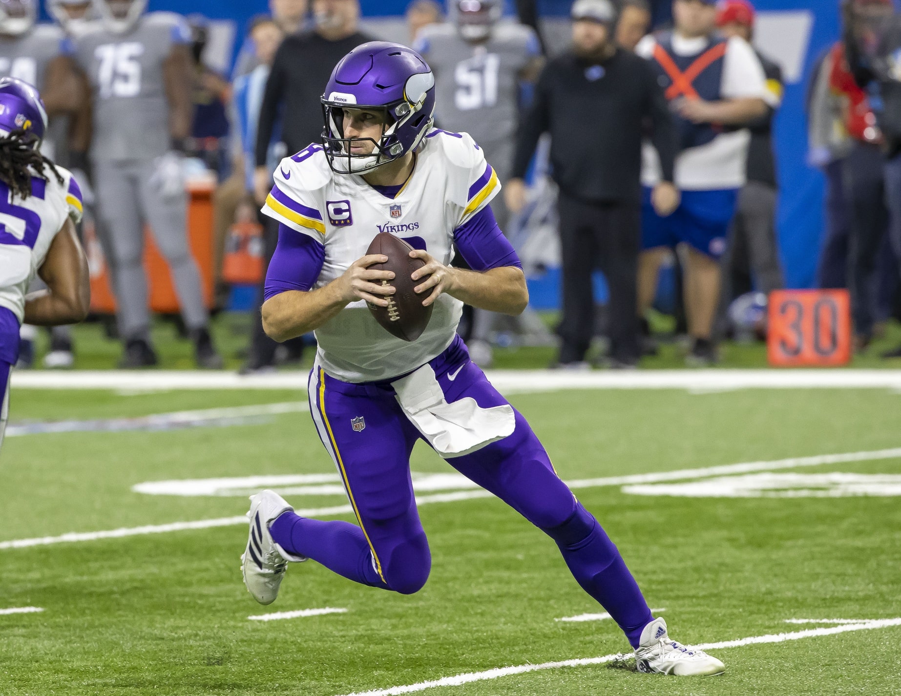 Minnesota Vikings quarterback Kirk Cousins (8) scrambles out of the pocket against the Detroit Lions in the first half at Ford Field.
