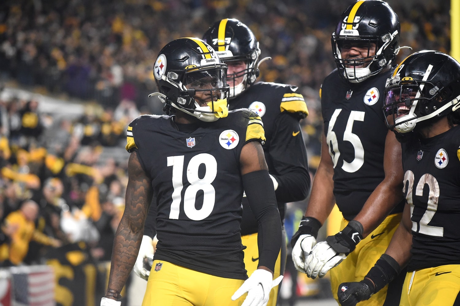 Pittsburgh Steelers wide receiver Diontae Johnson (18) celebrates a touchdown during the fourth quarter with offensive lineman John Leglue (77) and Dan Moore Jr. (65) and Najee Harris (22) against the Baltimore Ravens.