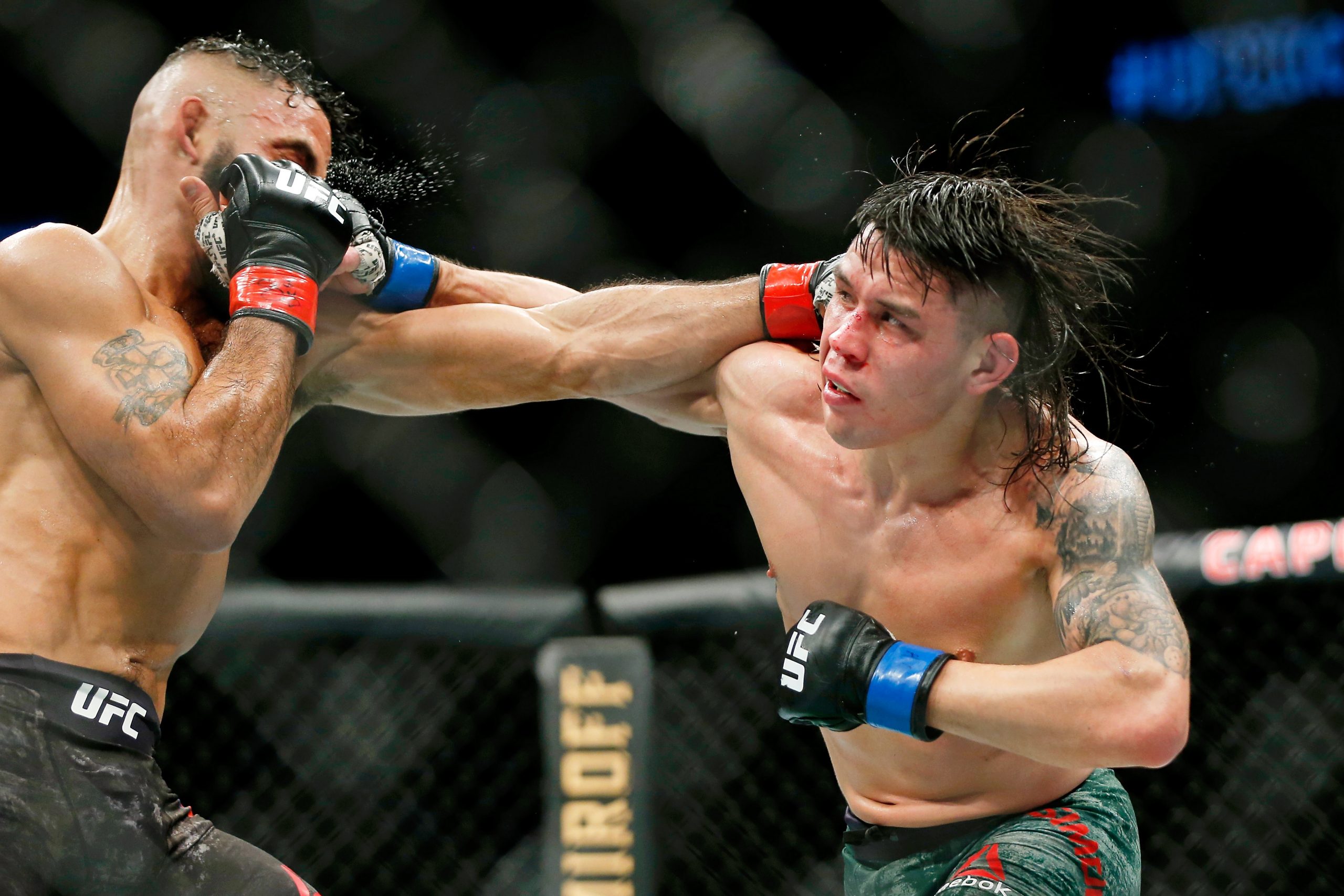 Dec 7, 2019; Washington, DC, USA; Rob Font (red gloves) fights Ricky Simon (blue gloves) during UFC Fight Night at Capital One Arena.