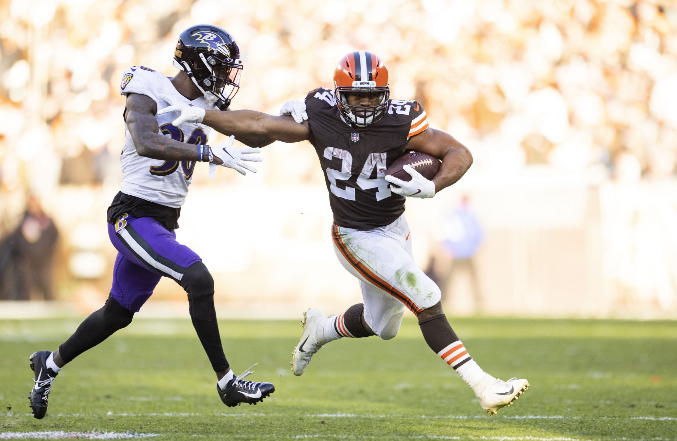 Cleveland Browns running back Nick Chubb (24) pushes off against Baltimore Ravens cornerback Chris Westry (30) during the fourth quarter at FirstEnergy Stadium.