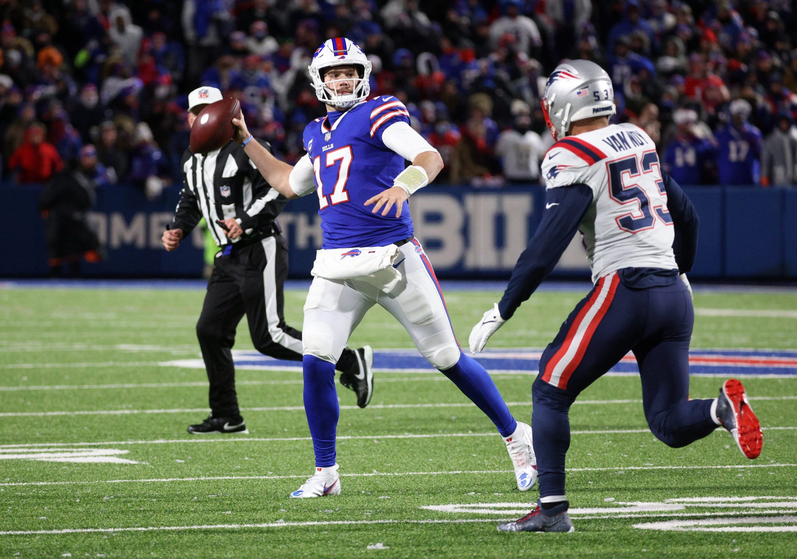 Bills quarterback Josh Allen looks downfield as he is pressured by Patriots Kyle Van Noy.