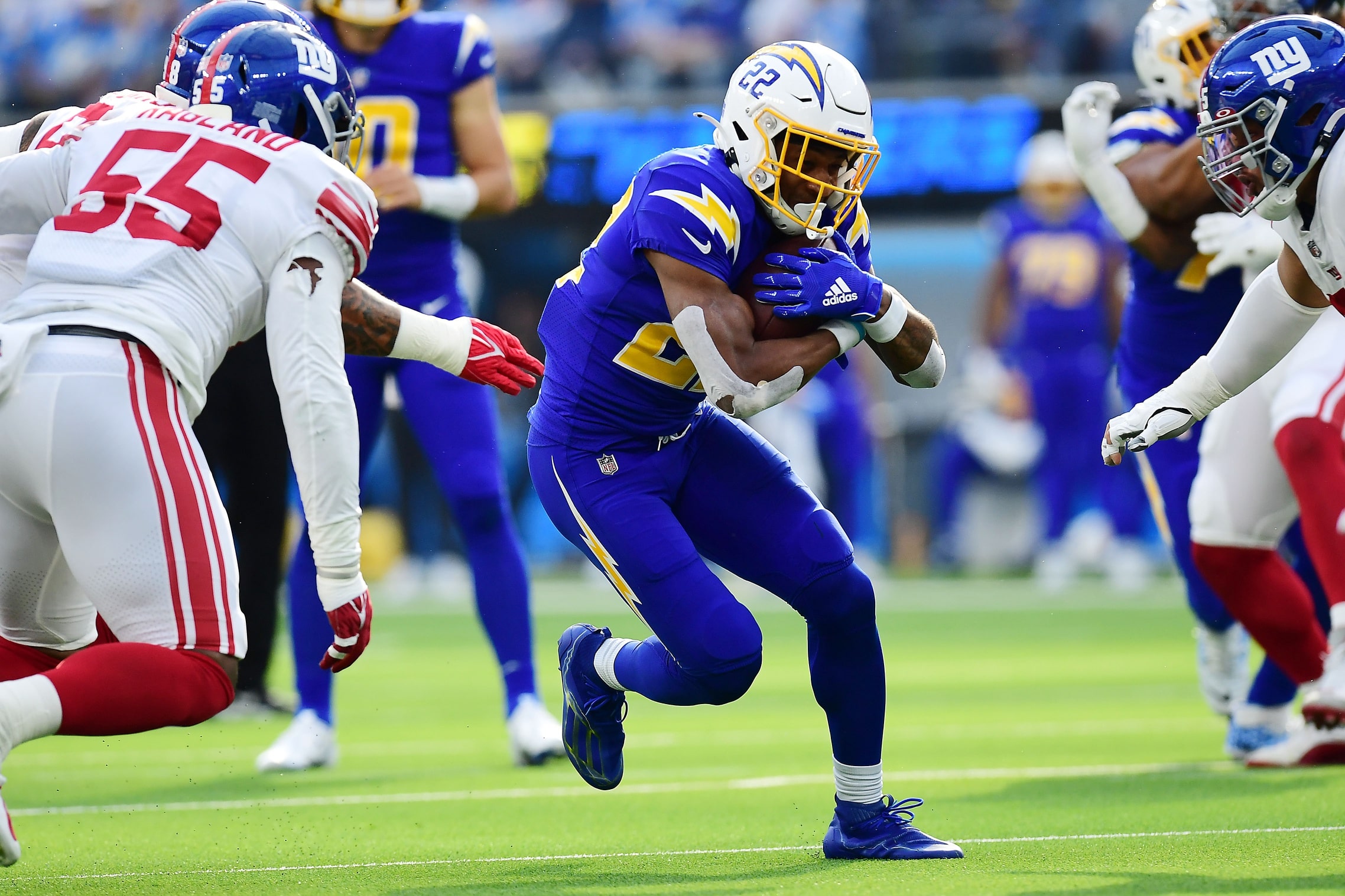 Los Angeles Chargers running back Justin Jackson (22) runs the ball against New York Giants inside linebacker Reggie Ragland (55) during the first half at SoFi Stadium.