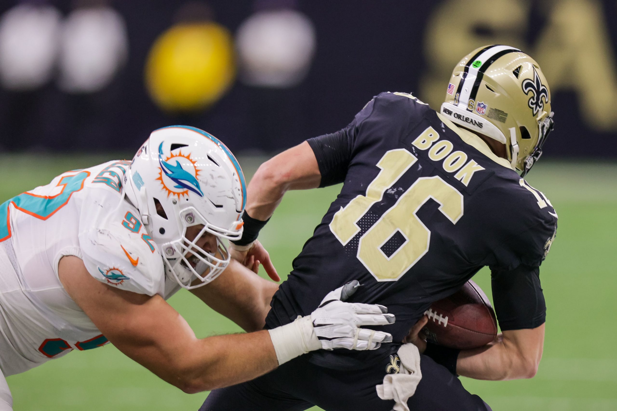 Miami Dolphins defensive end Zach Sieler (92) sacks New Orleans Saints quarterback Ian Book (16) during the second half at Caesars Superdome