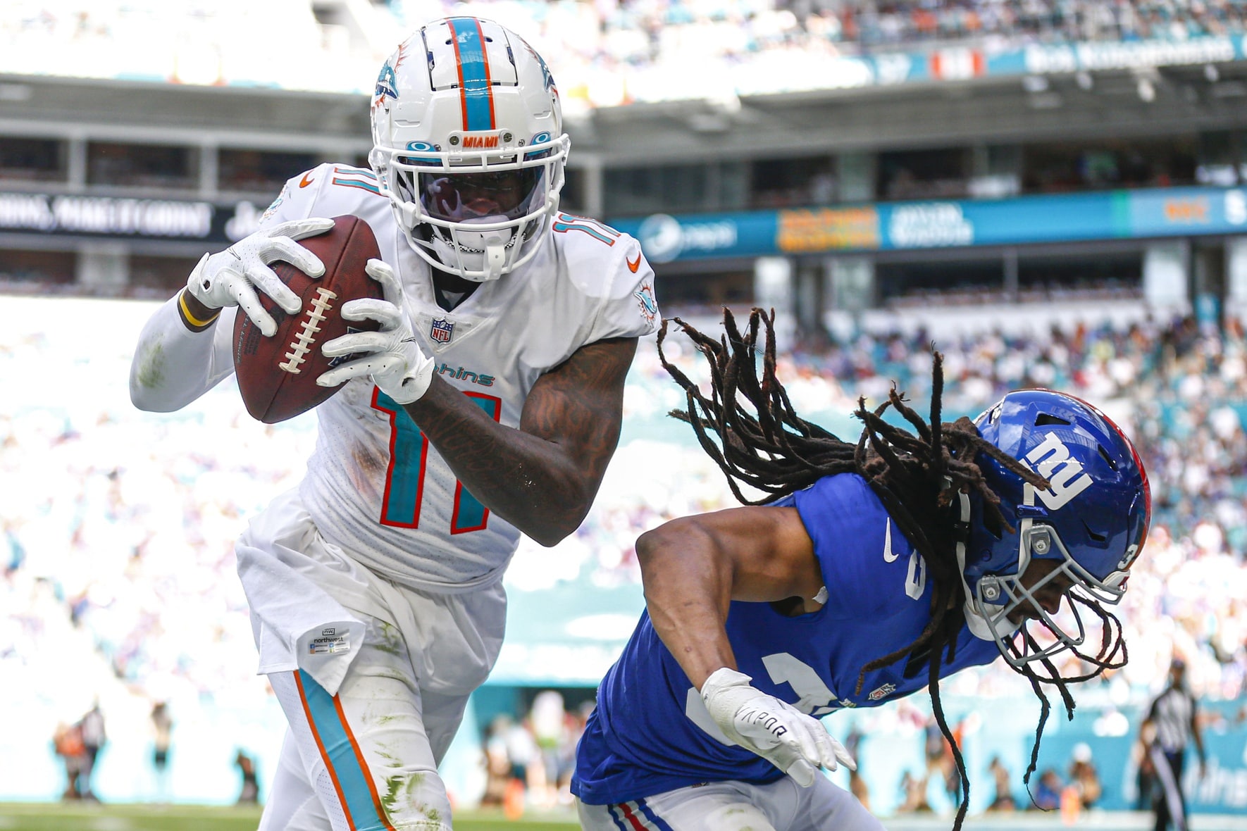 Miami Dolphins wide receiver DeVante Parker (11) catches the football against New York Giants cornerback Aaron Robinson (33) during the first half at Hard Rock Stadium.