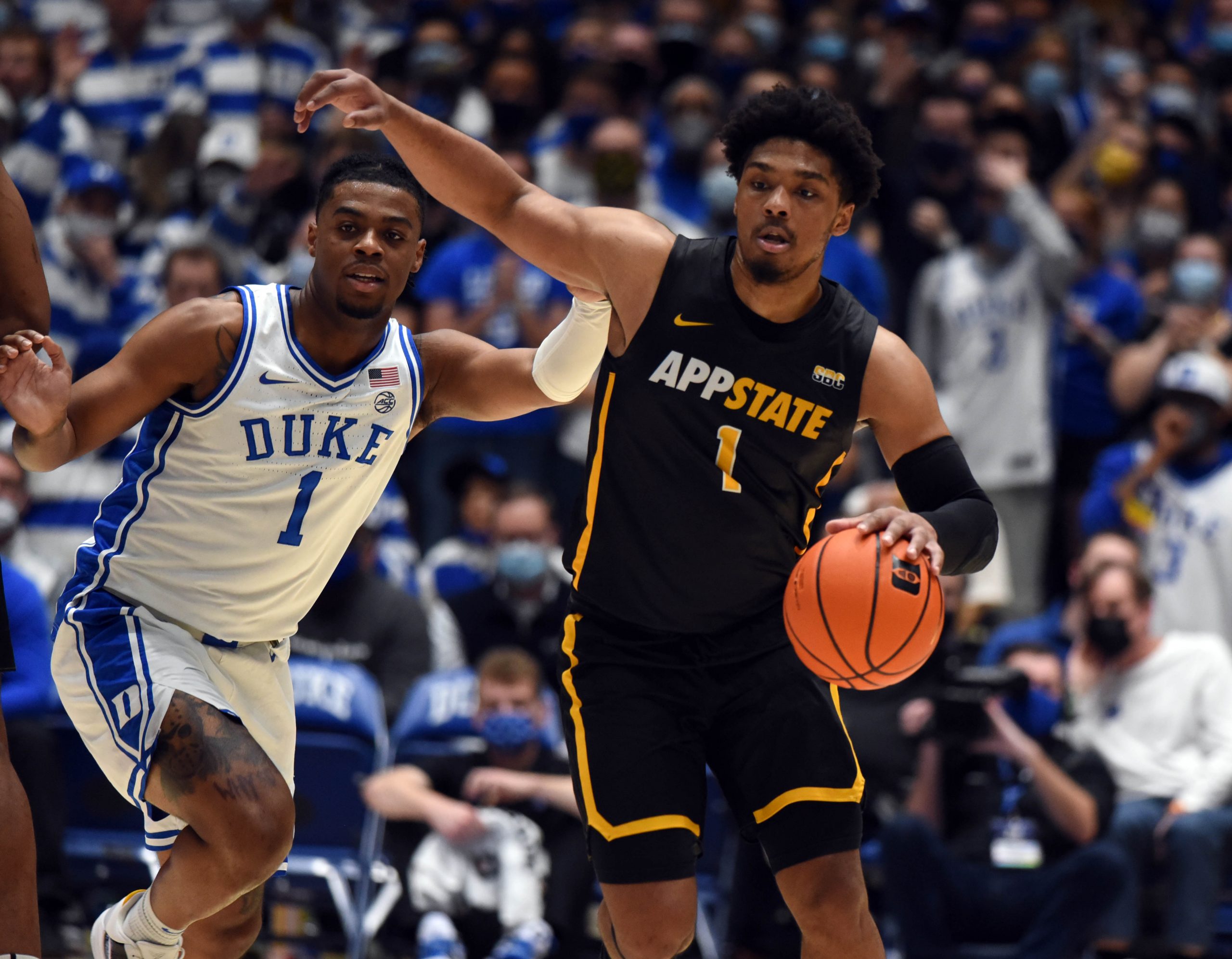 Appalachian State Mountaineers guard Justin Forrest (1) dribbles up court as Duke Blue Devils guard Trevor Keels (1) defends during the first half at Cameron Indoor Stadium