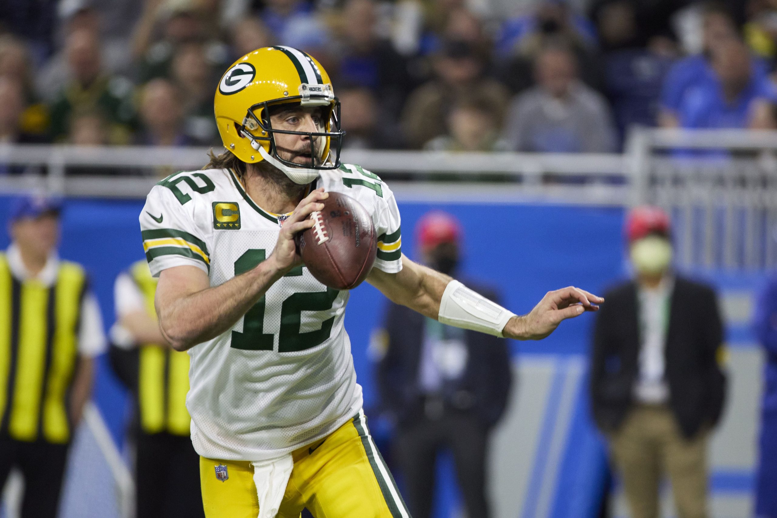 Green Bay Packers quarterback Aaron Rodgers (12) scrambles against the Detroit Lions during an NFL football game, Sunday, Jan. 9, 2022, in Detroit