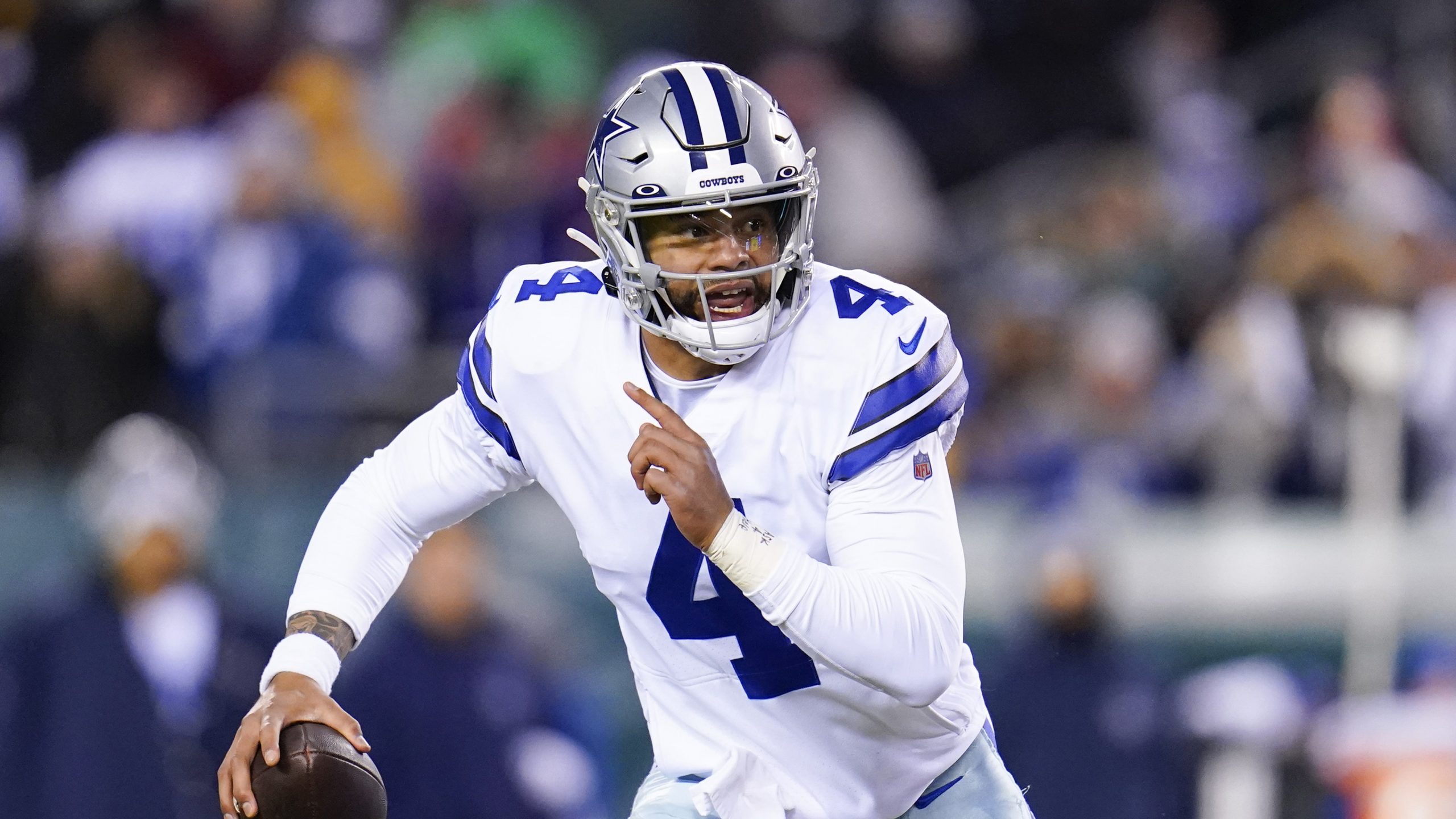 Dallas Cowboys quarterback Dak Prescott rolls out during the first half of an NFL football game between the Philadelphia Eagles and the Dallas Cowboys, Saturday, Jan. 8, 2022, in Philadelphia