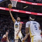 Golden State Warriors guard Stephen Curry (30) lays up up the ball against the Cleveland Cavaliers during the second half of an NBA basketball game in San Francisco, Sunday, Jan. 9, 2022