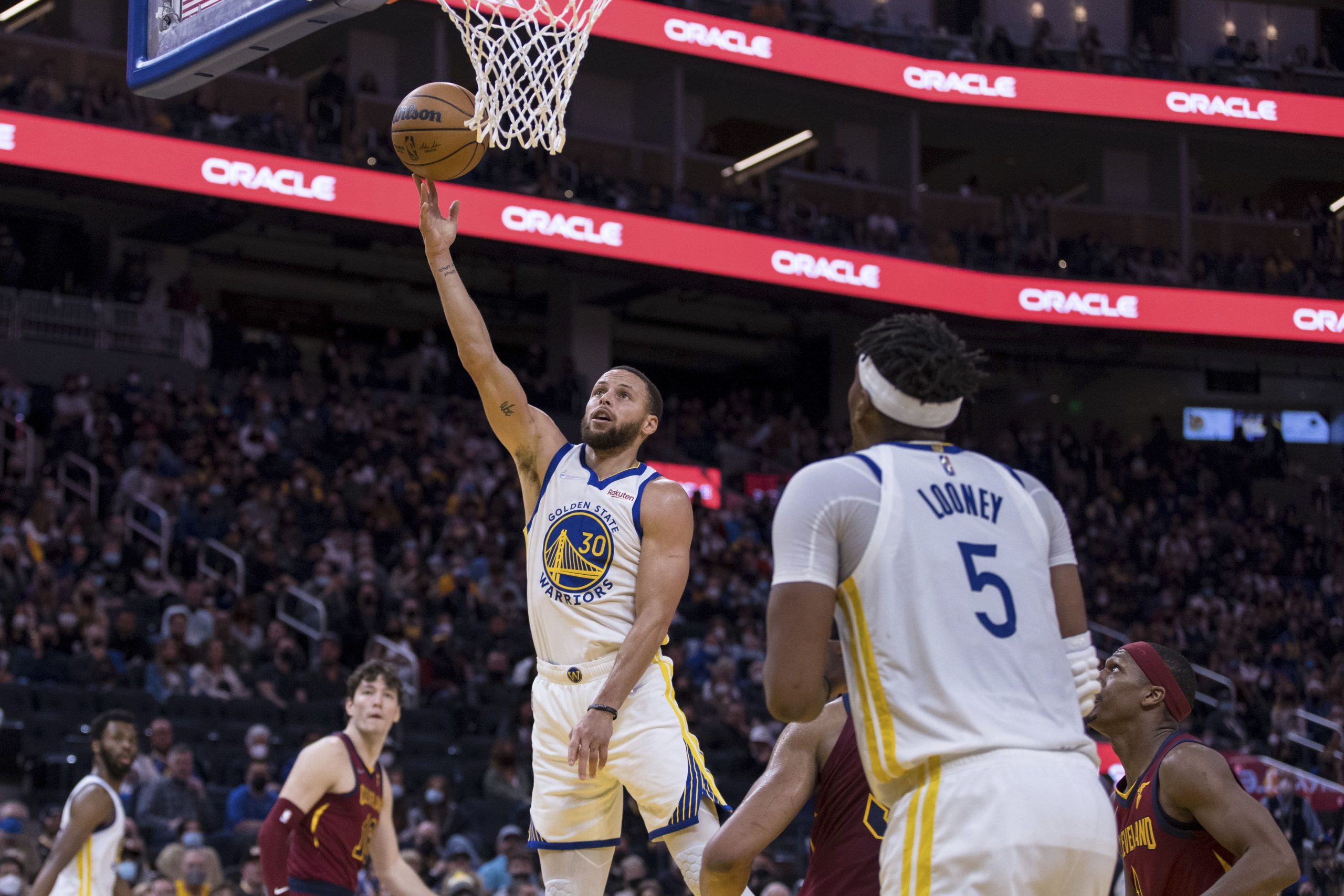 Golden State Warriors guard Stephen Curry (30) lays up up the ball against the Cleveland Cavaliers during the second half of an NBA basketball game in San Francisco, Sunday, Jan. 9, 2022