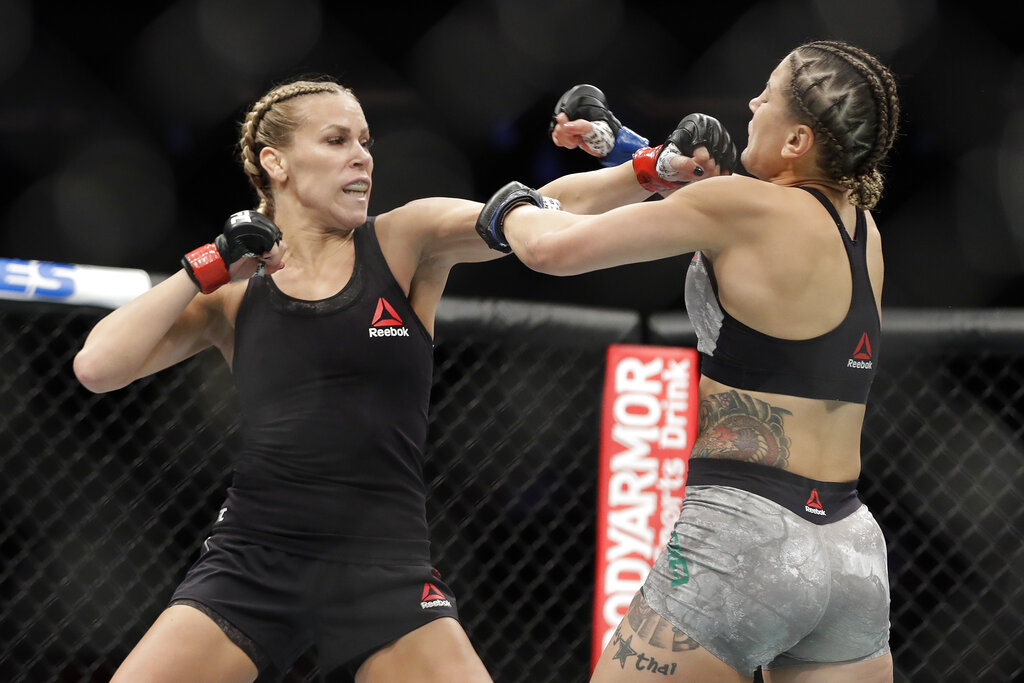 Katlyn Chookagian, left, punches Brazil's Jennifer Maia during the first round of a women's flyweight mixed martial arts bout at UFC 244, Saturday, Nov. 2, 2019, in New York. Chookagian won the fight.
