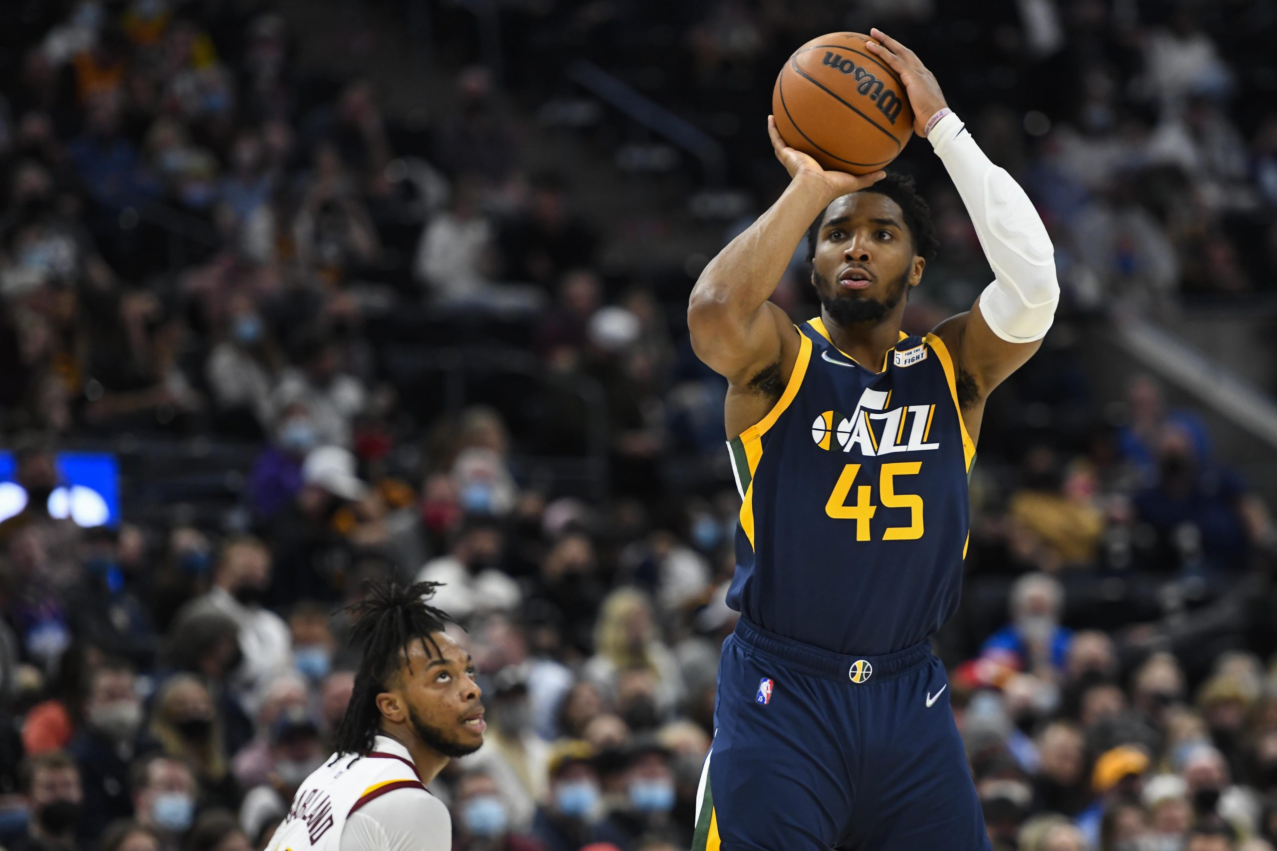 Utah Jazz guard Donovan Mitchell (45) shoots over Cleveland Cavaliers guard Darius Garland, left, during the second half of an NBA basketball game Wednesday, Jan. 12, 2022, in Salt Lake City.