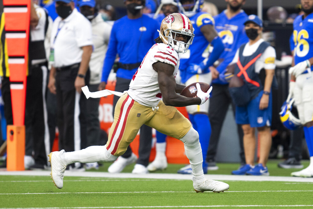 San Francisco 49ers wide receiver Brandon Aiyuk (11) runs with the ball during an NFL football game against the Los Angeles Rams Sunday, Jan. 9, 2022, in Inglewood, Calif.