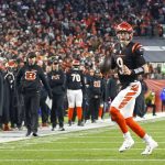 Cincinnati Bengals quarterback Joe Burrow (9) prepares to throw a touchdown pass to wide receiver Tyler Boyd during the first half of an NFL wild-card playoff football game, Saturday, Jan. 15, 2022, in Cincinnati.