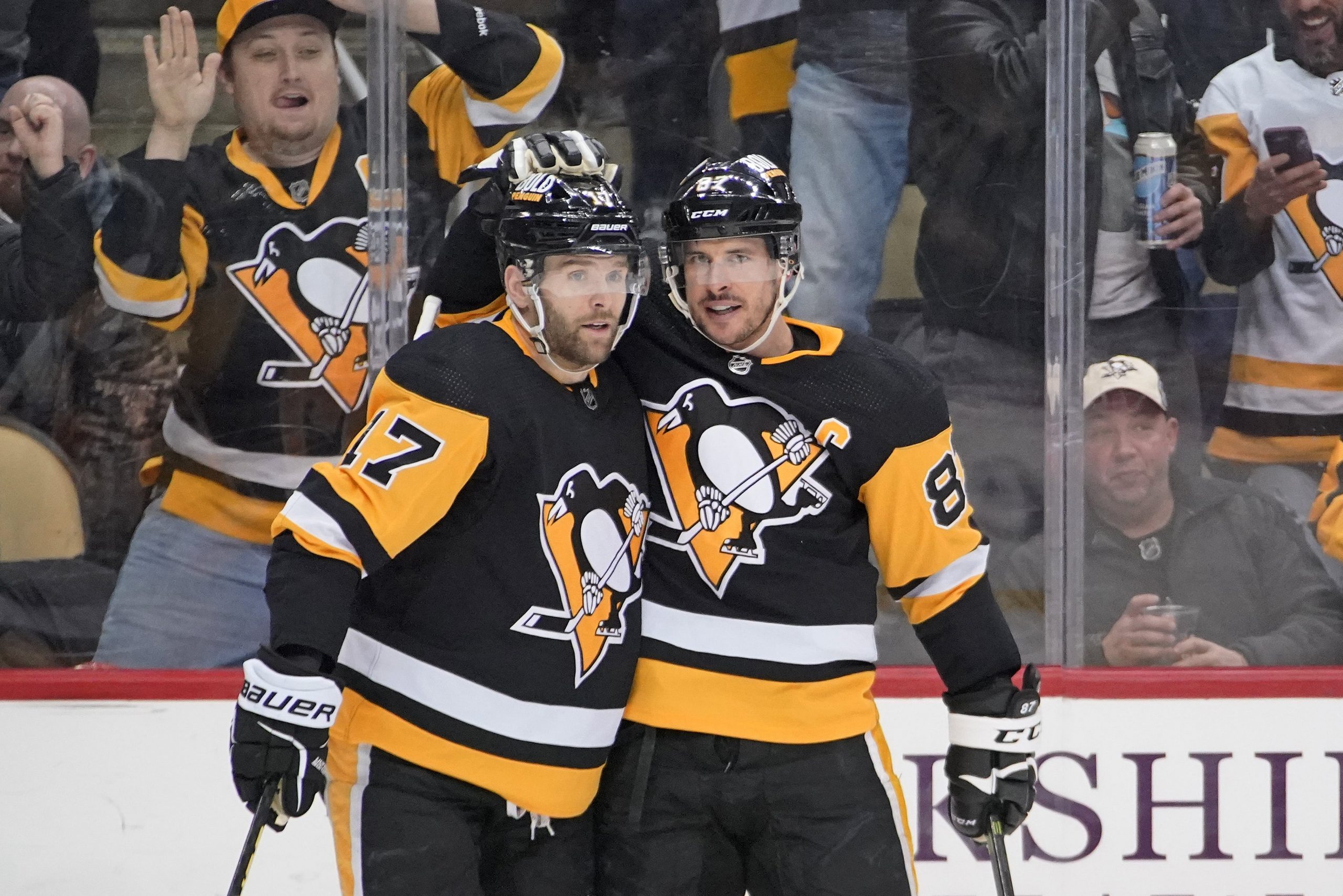 Pittsburgh Penguins' Sidney Crosby (87) celebrates his goal against the Ottawa Senators with Bryan Rust during the second period of an NHL hockey game in Pittsburgh, Thursday, Jan. 20, 2022