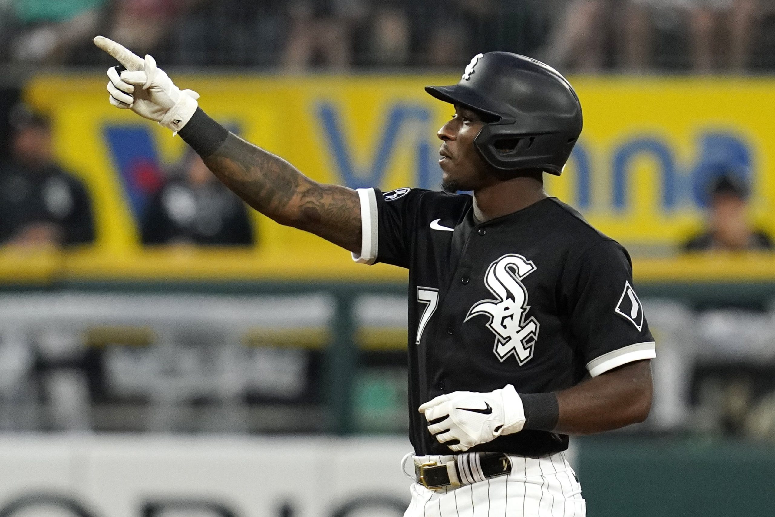Chicago White Sox's Tim Anderson smiles as he points to the dugout after hitting a double during the sixth inning of the team's baseball game against the Houston Astros in Chicago, Saturday, July 17, 2021.