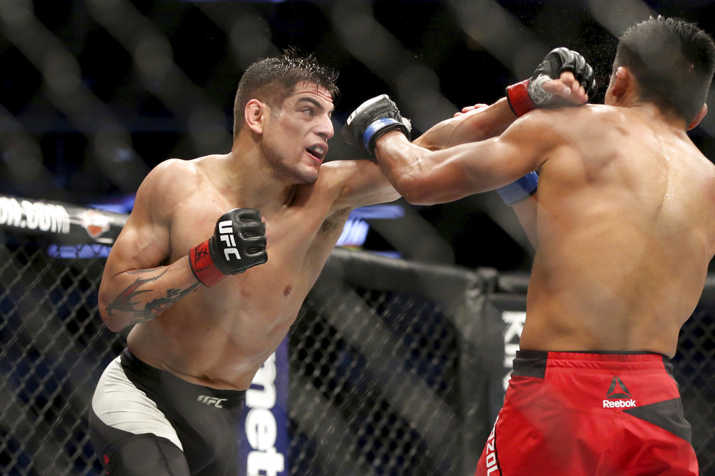 Enrique Barzola, right, fights Gabriel Benitez in a mixed martial arts bout at UFC 211 on Saturday, May 13, 2017, in Dallas. Barboza won via decision.